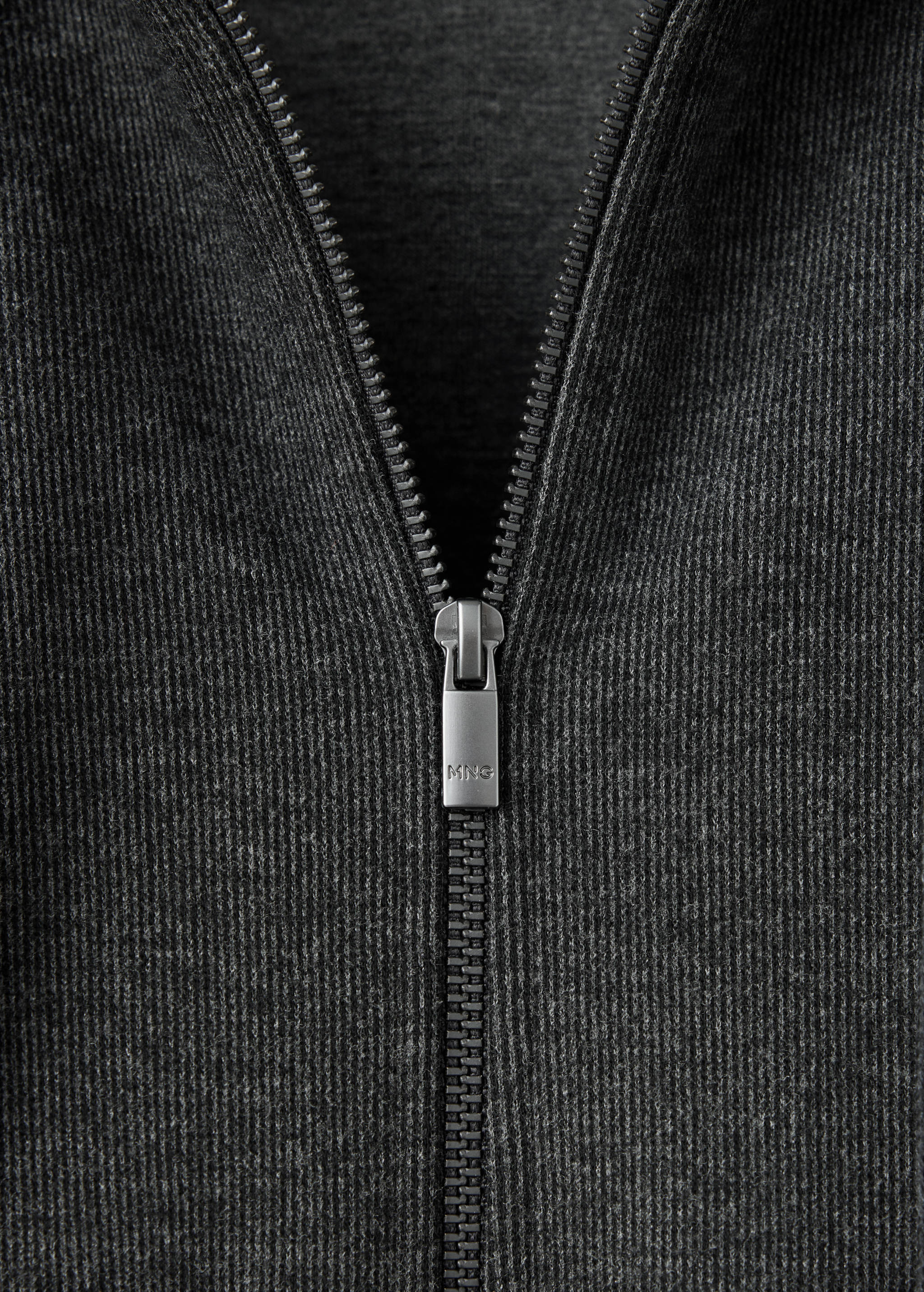 Close-up of a dark grey sweatshirt zip collar.