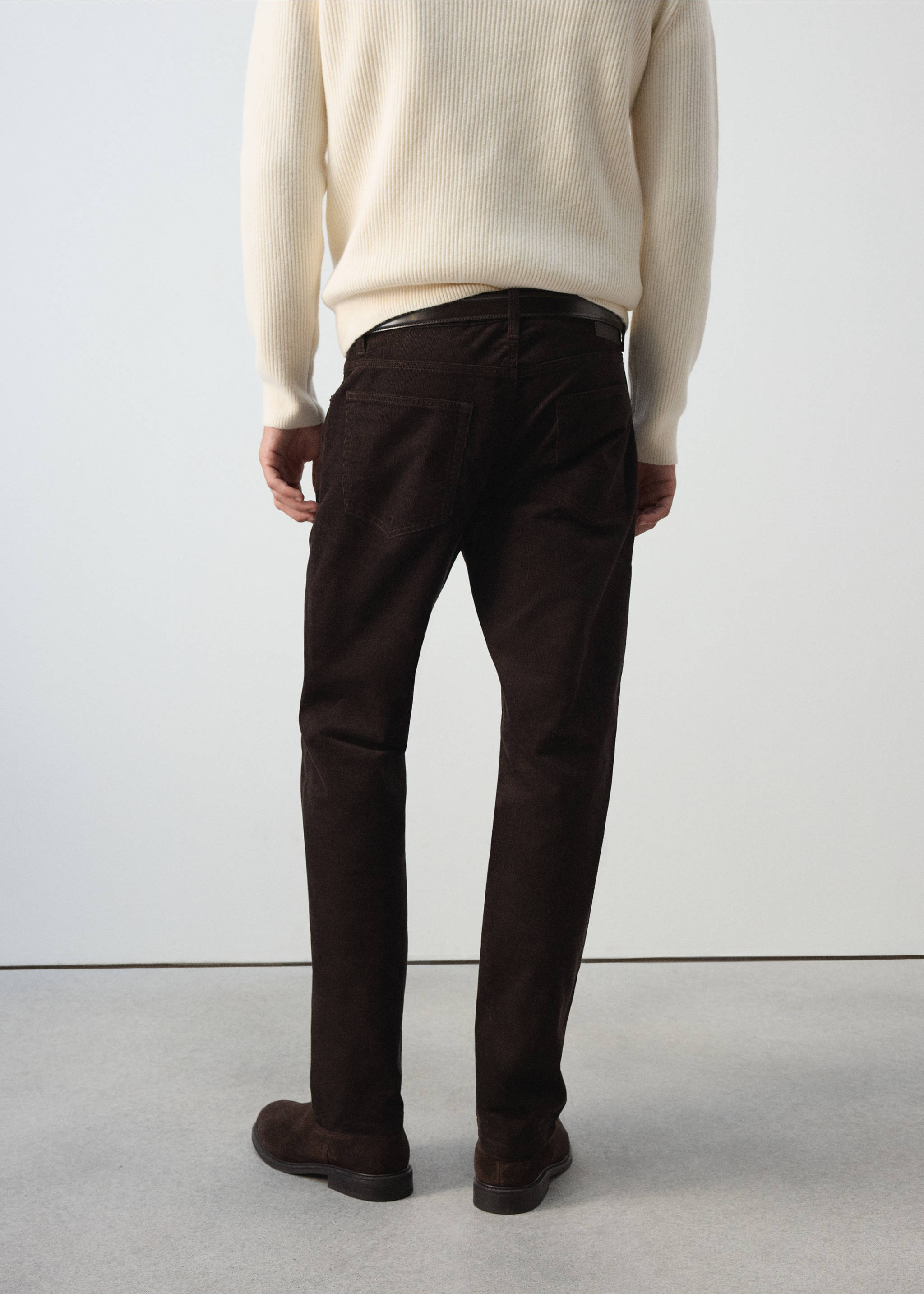 Dark brown corduroy trousers seen from the back, worn with a cream sweater., Chocolate. Ref: 37037900-00.