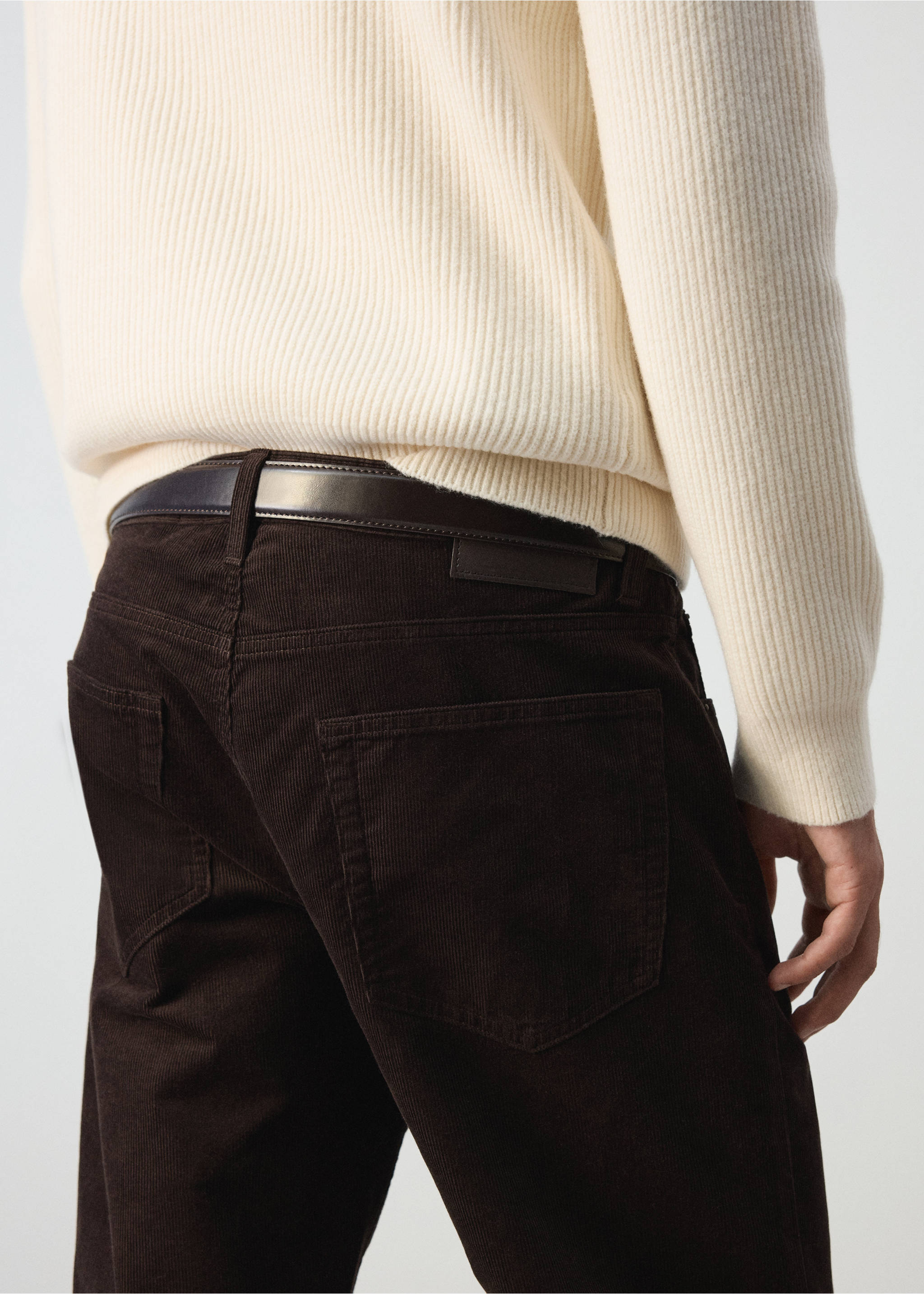 Dark brown corduroy trousers with rear pockets, worn with a belt and a cream sweater., Chocolate. Ref: 37037900-00.