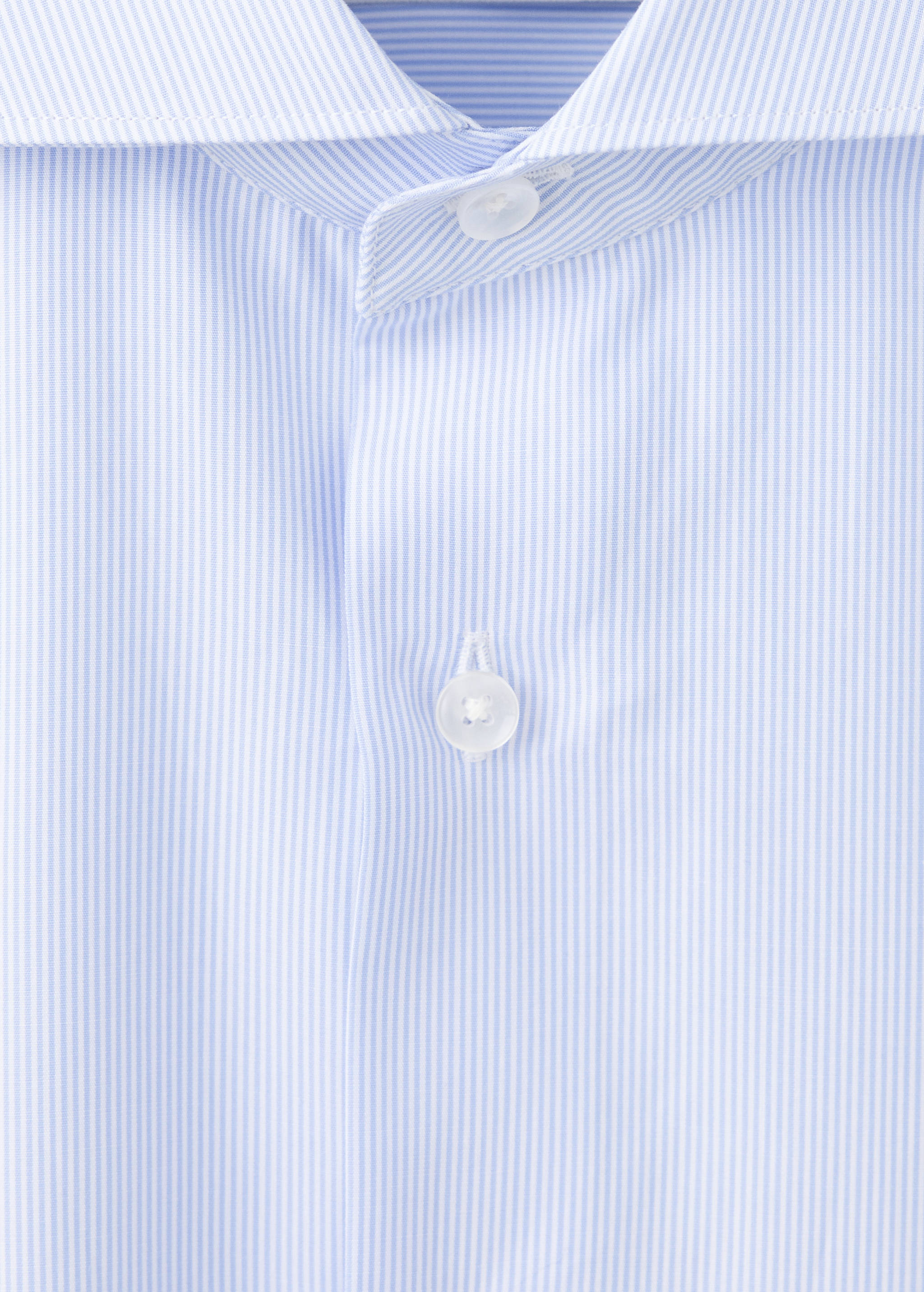 Close-up of a light blue and white striped shirt collar and placket.