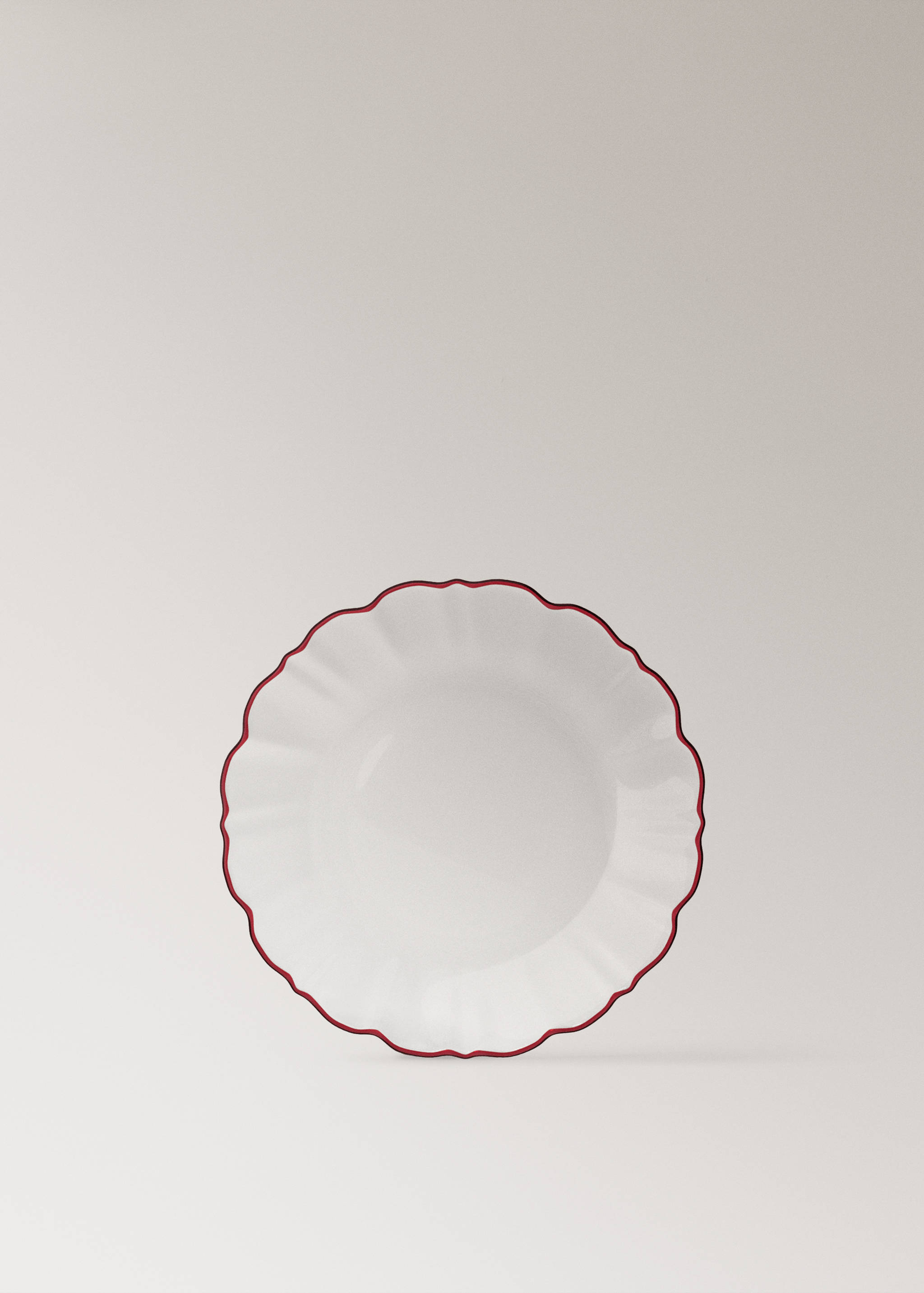 White plate with a wavy rim and a red border.