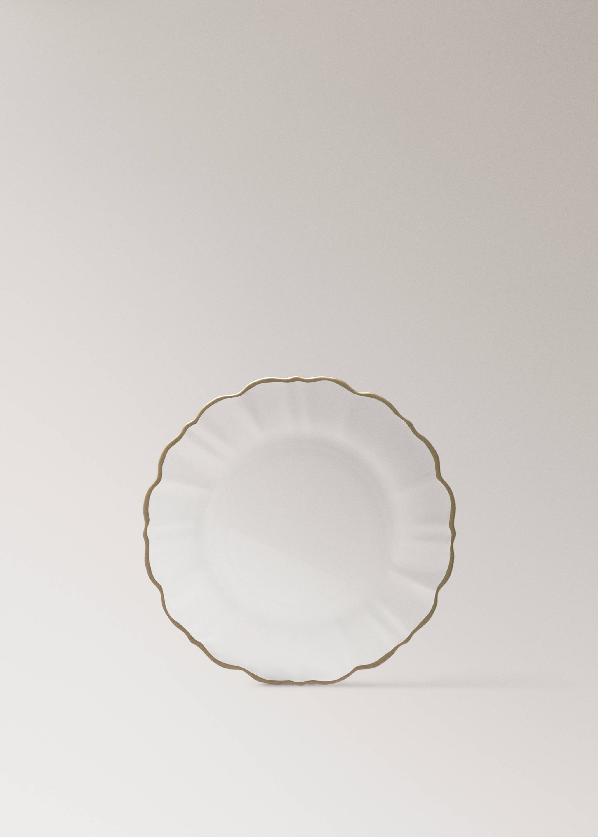 White plate featuring a scalloped rim with a gold-toned border.