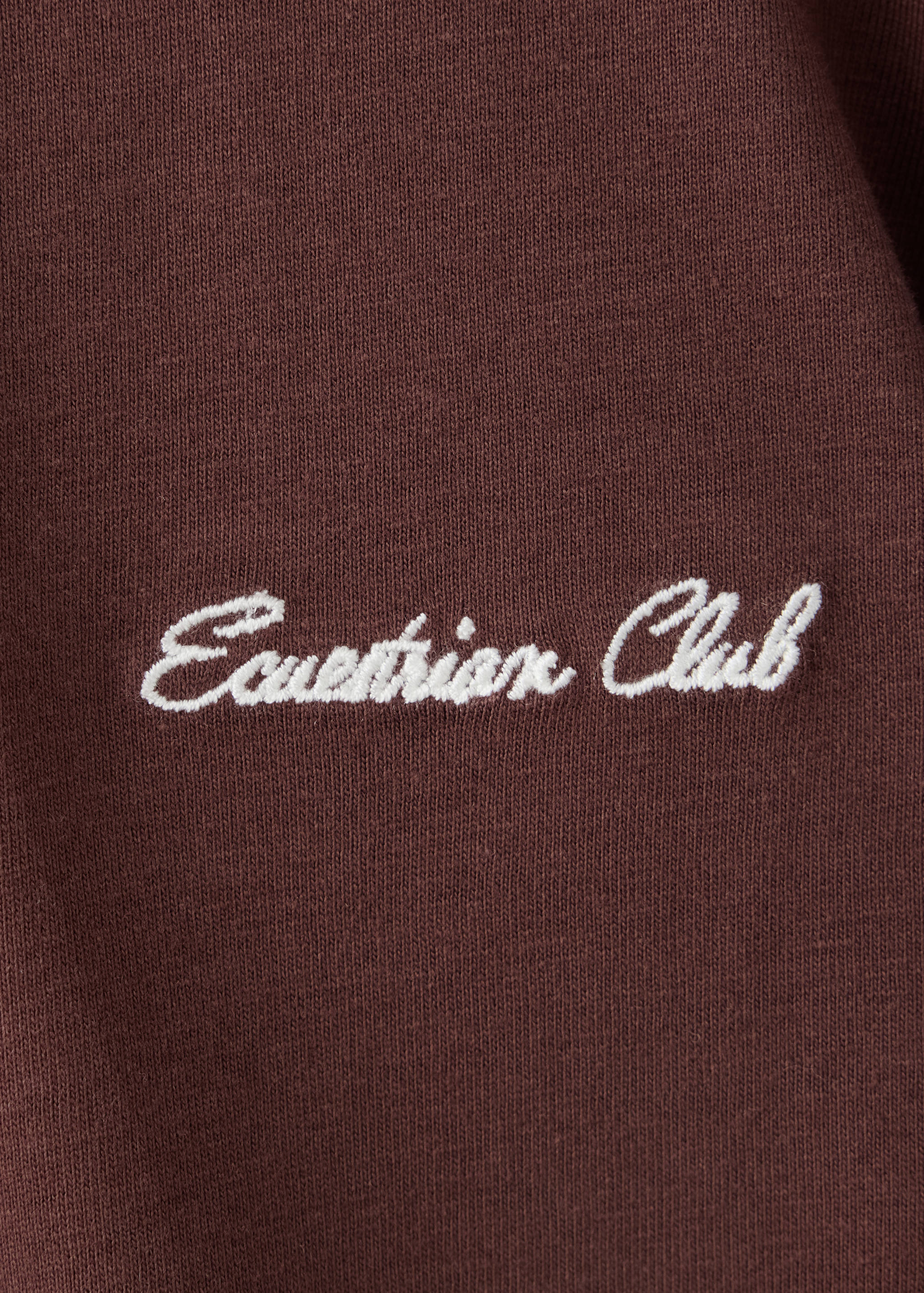 Brown kids' t-shirt detail with white Equestrian Club embroidery