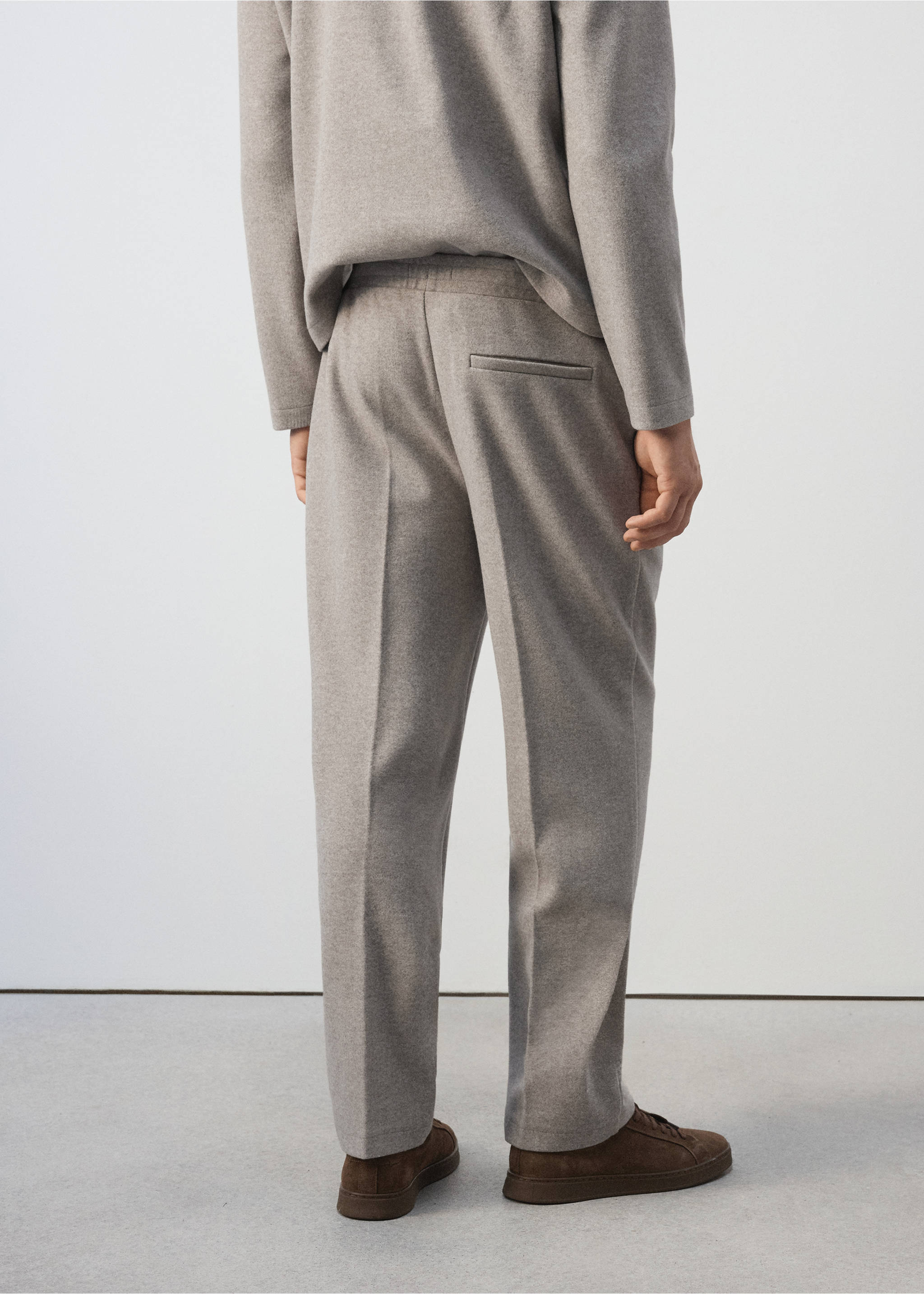Light grey joggers viewed from the back, featuring an elasticated waistband and a back pocket., Light/Pastel Grey. Ref: 37037915-00.