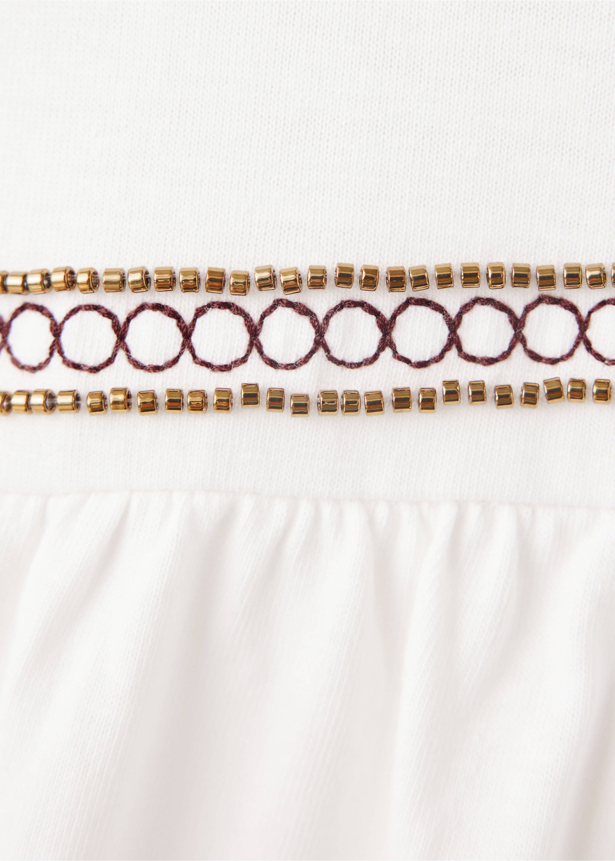 Close-up of a white T-shirt with beaded and embroidered trim., Off White. Ref: 37037921-00.