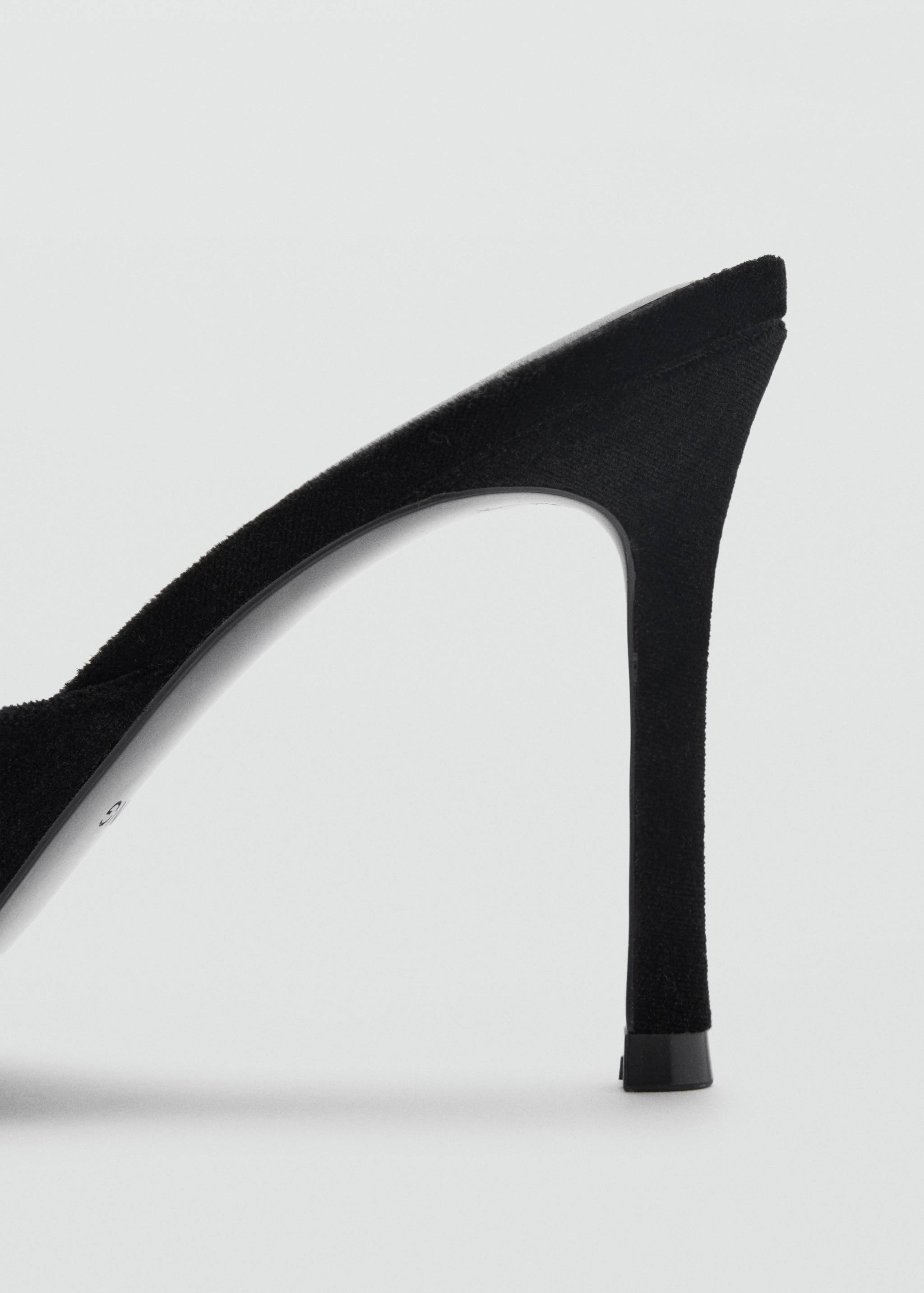 Close-up of the black heel on a heeled sandal.