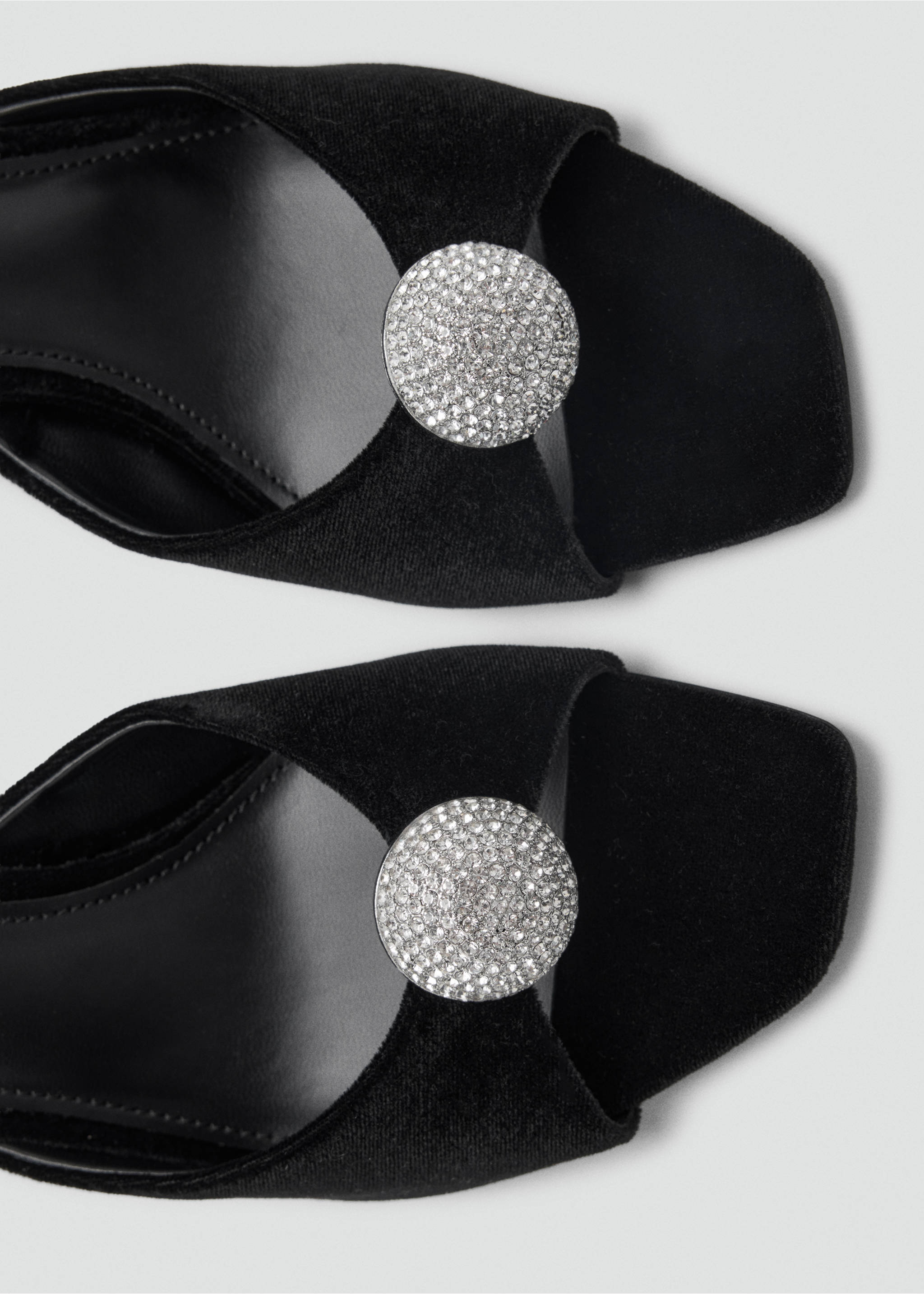 Close-up of black velvet sandals featuring a square toe and a circular rhinestone medallion detail., Black. Ref: 37037928-00.