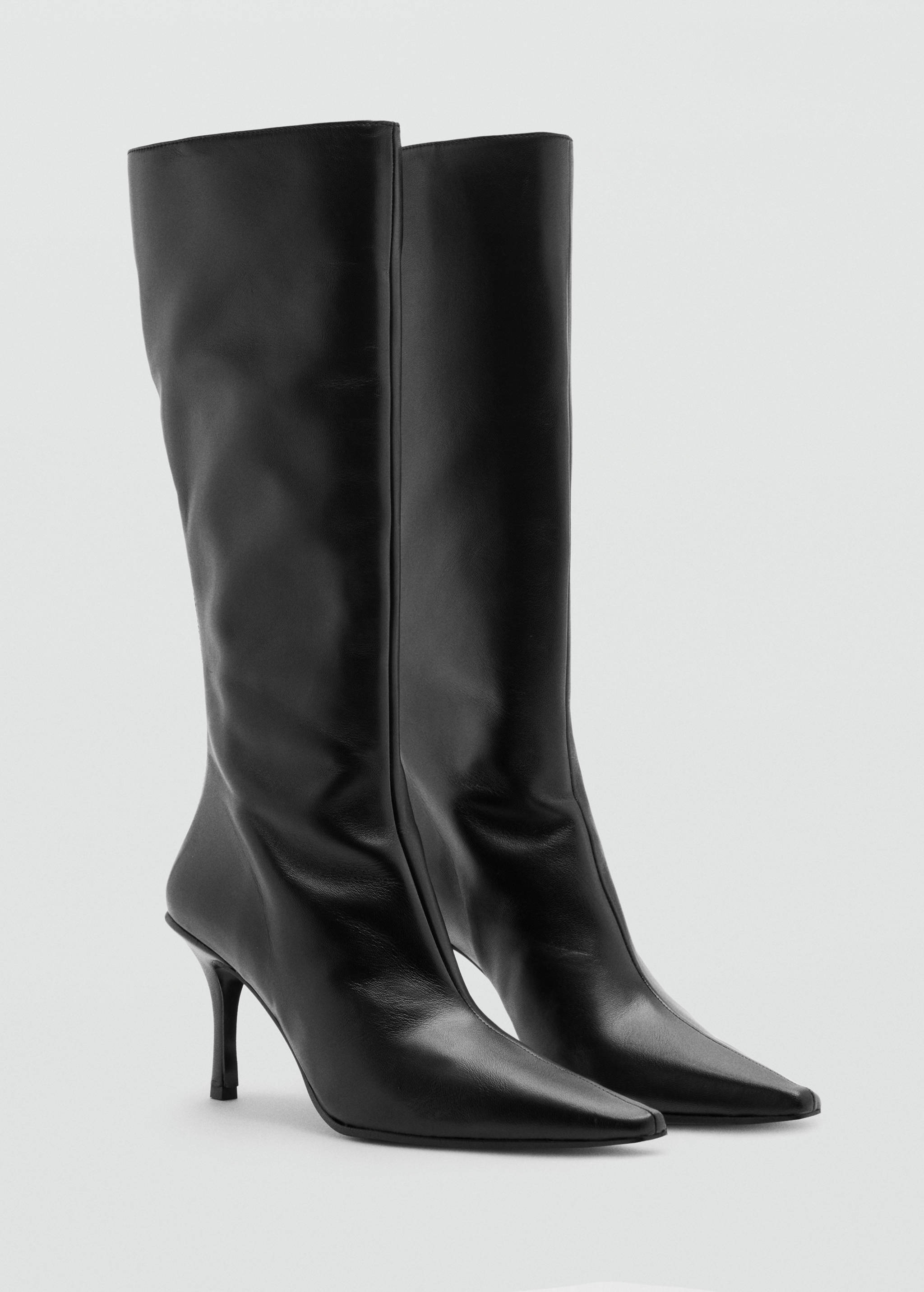Black knee-high leather boots with pointed toes and stiletto heels.