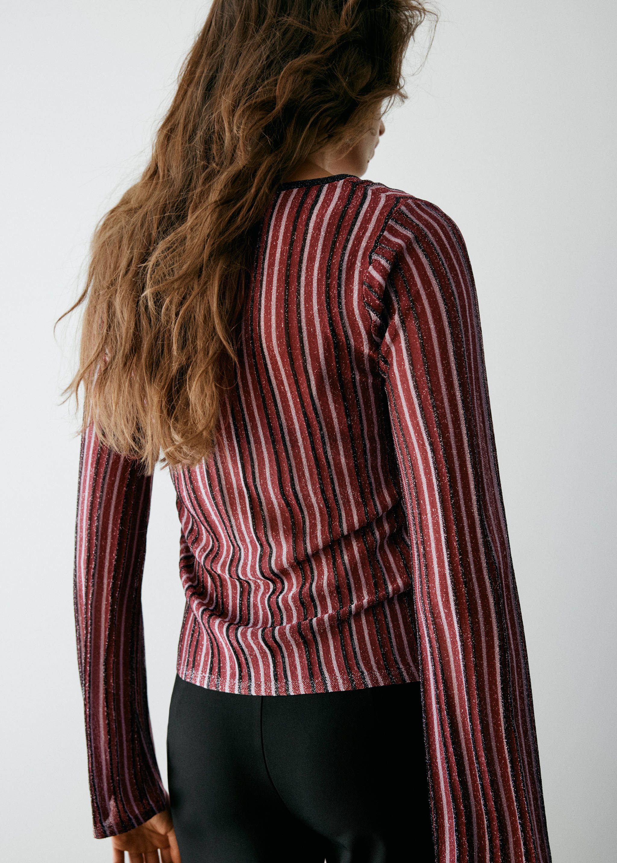 Striped metallic jersey with long flared sleeves, shown from the back.