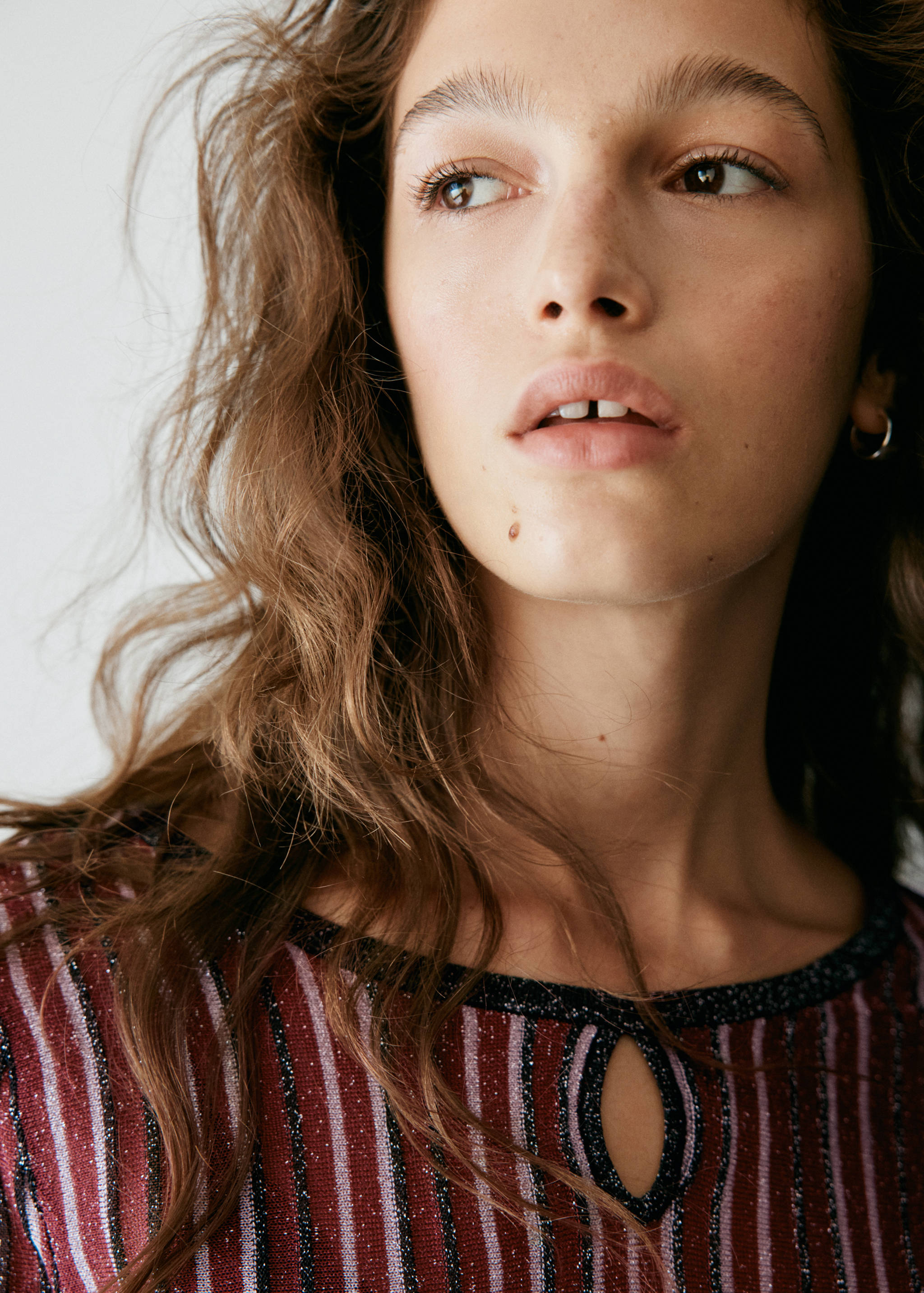 Close-up of a striped metallic knit jersey with a keyhole neckline.