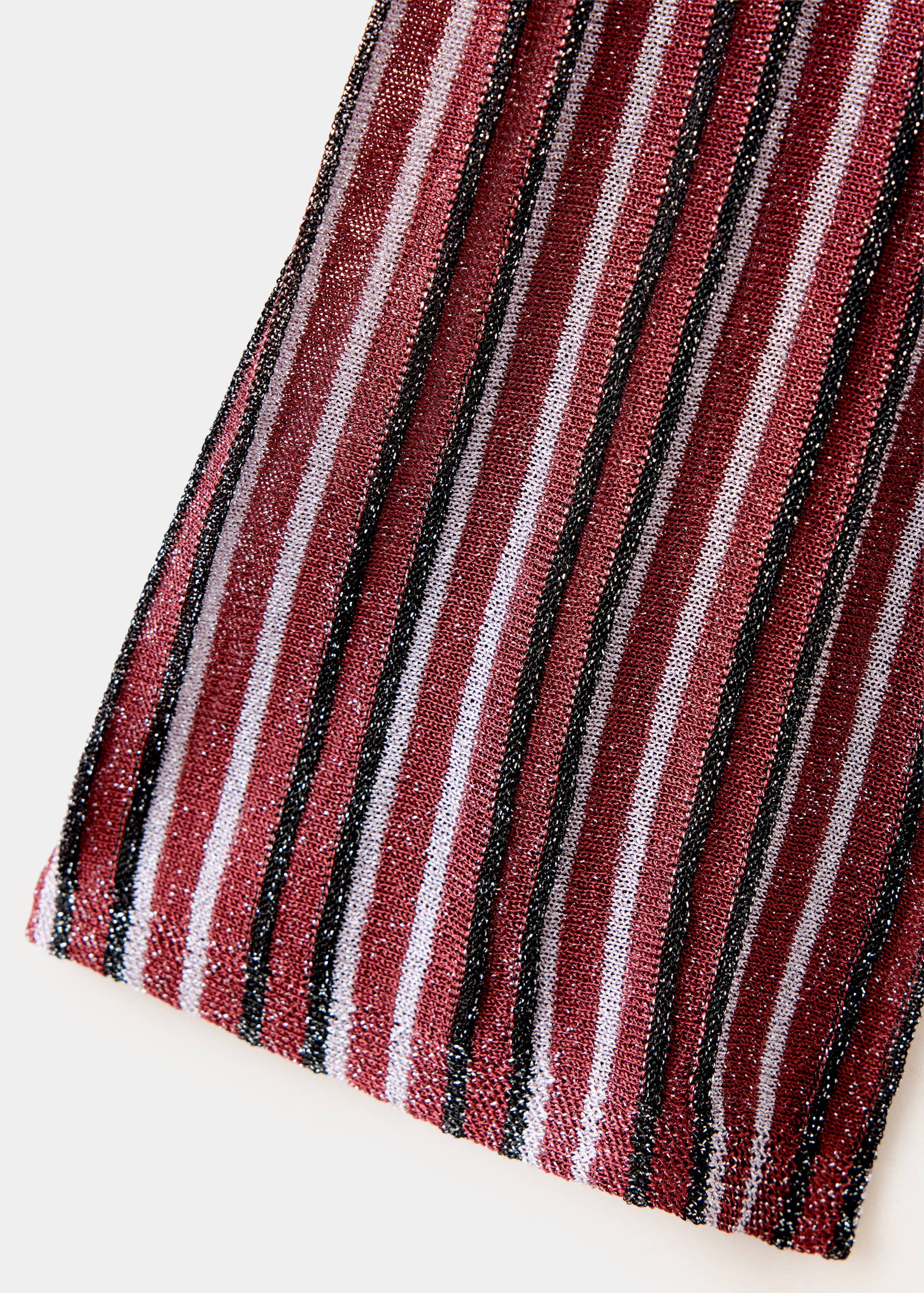 Close-up of a metallic-thread ribbed knit jersey with dark red, white, and black vertical stripes.