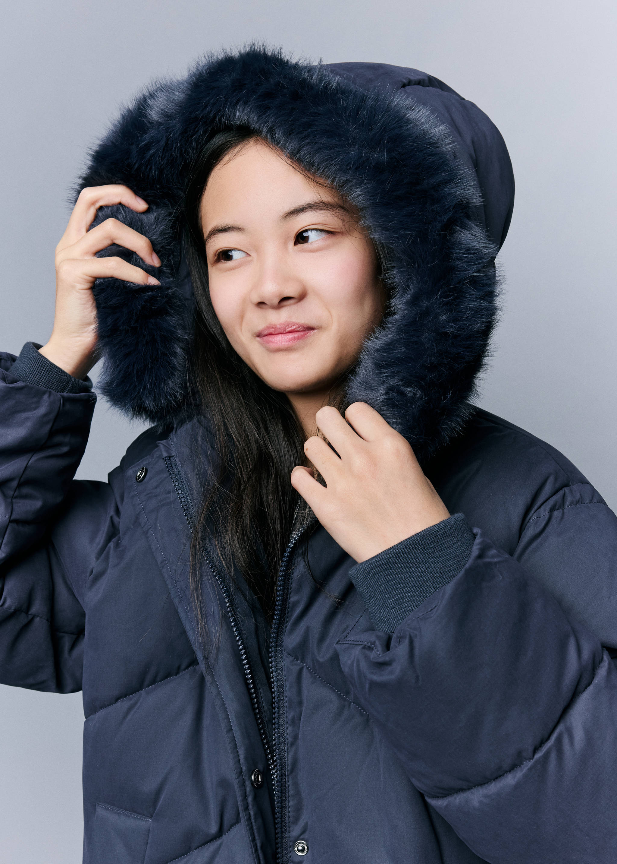 Navy blue padded anorak with a faux-fur trimmed hood.