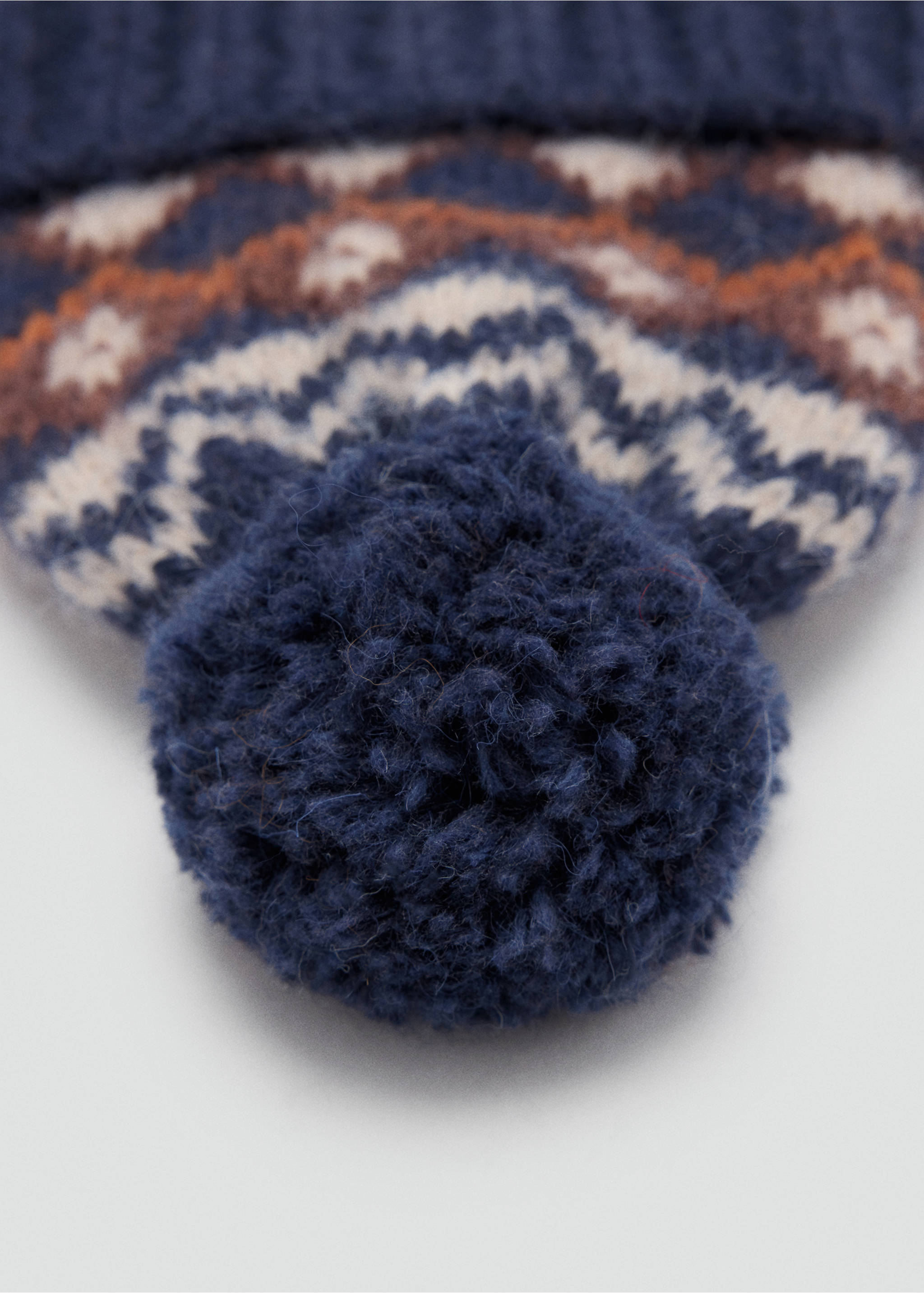 Close-up of a navy blue kids knit beanie with a Fair Isle pattern and pom-pom., Navy. Ref: 37038266-00.