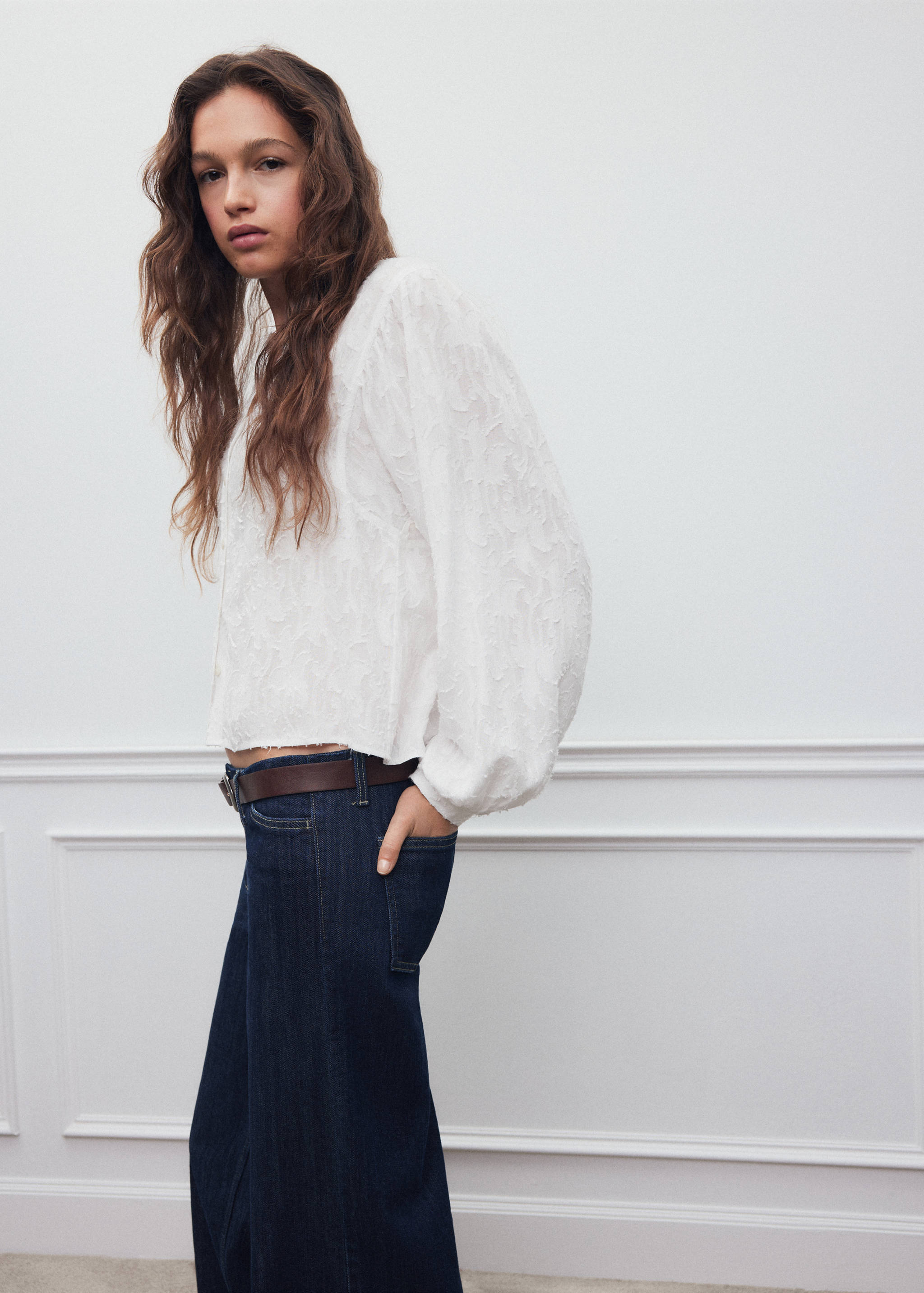 White textured long-sleeve shirt with voluminous bishop sleeves.