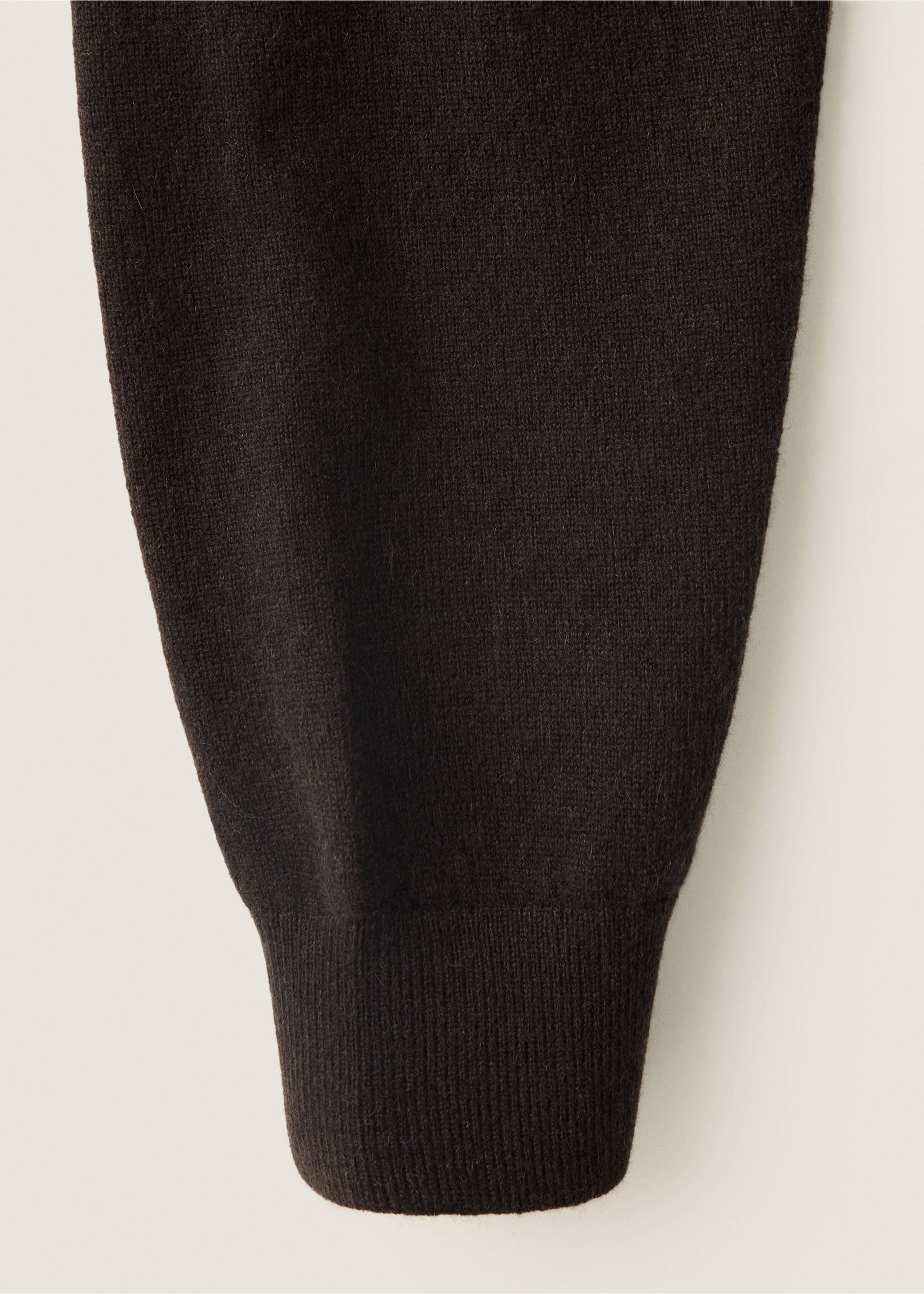 Close-up of the fine-knit texture and ribbed cuff on a dark brown jersey., Chocolate. Ref: 37038276-00.