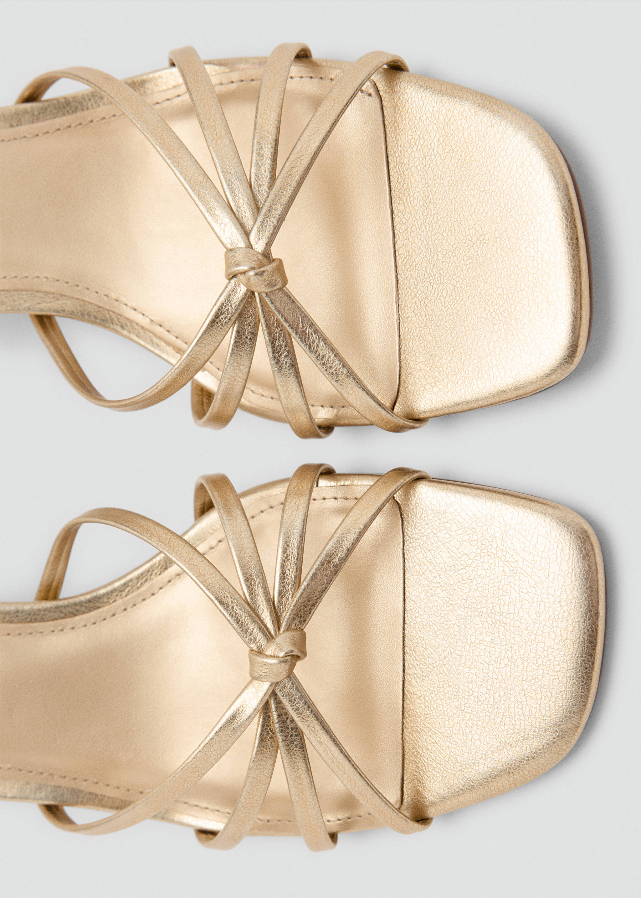 Close-up of metallic gold strappy sandals with square toes and front knot detail., Gold. Ref: 37038280-00.