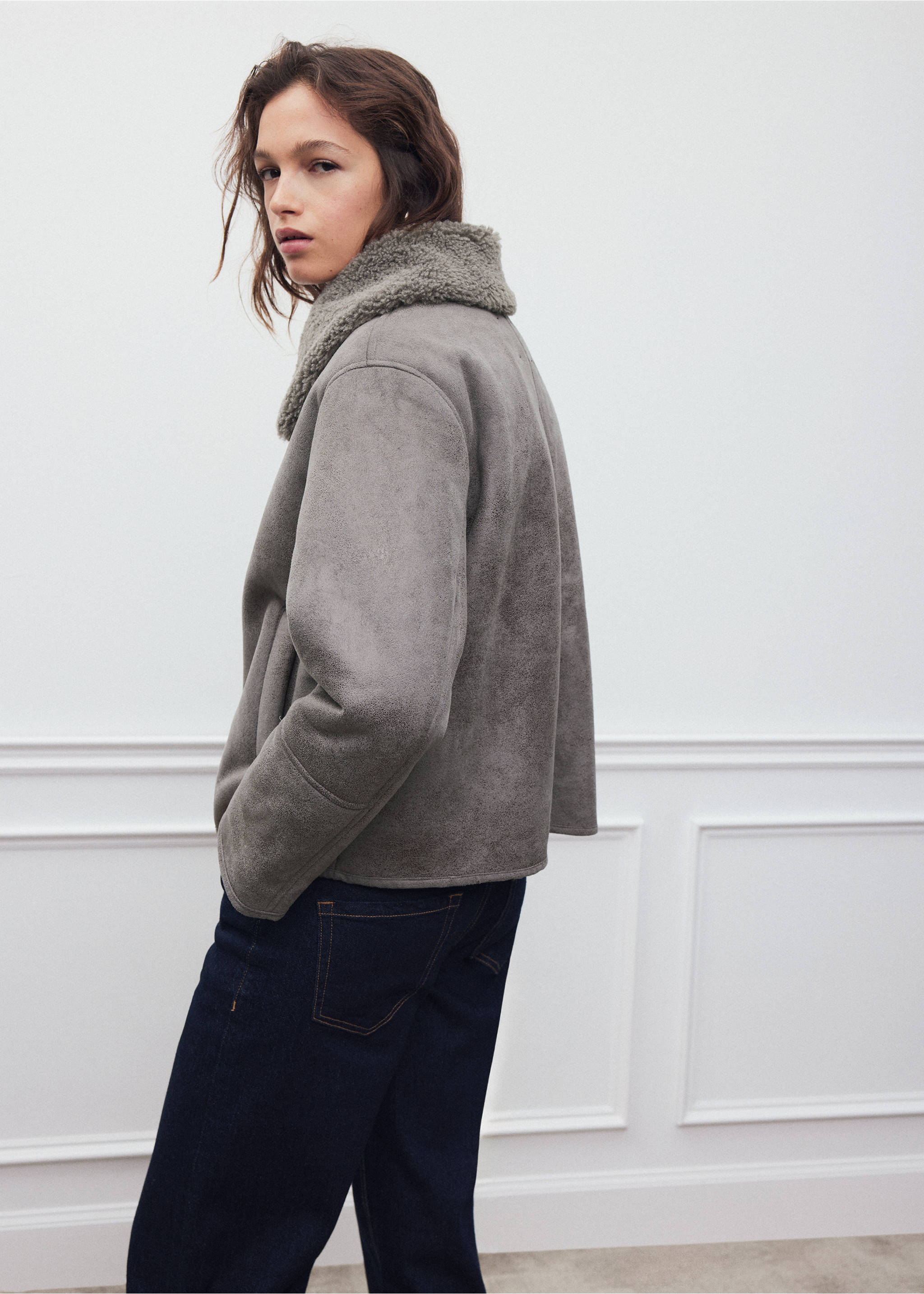 Grey faux-shearling coat seen from the back, paired with dark blue denim trousers., Grey. Ref: 37038282-00.