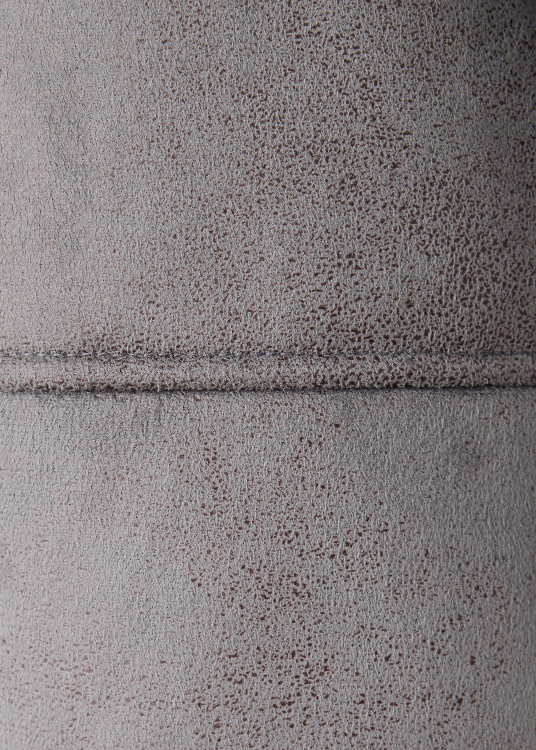 Close-up of brown coat fabric with a textured suede-effect finish.
