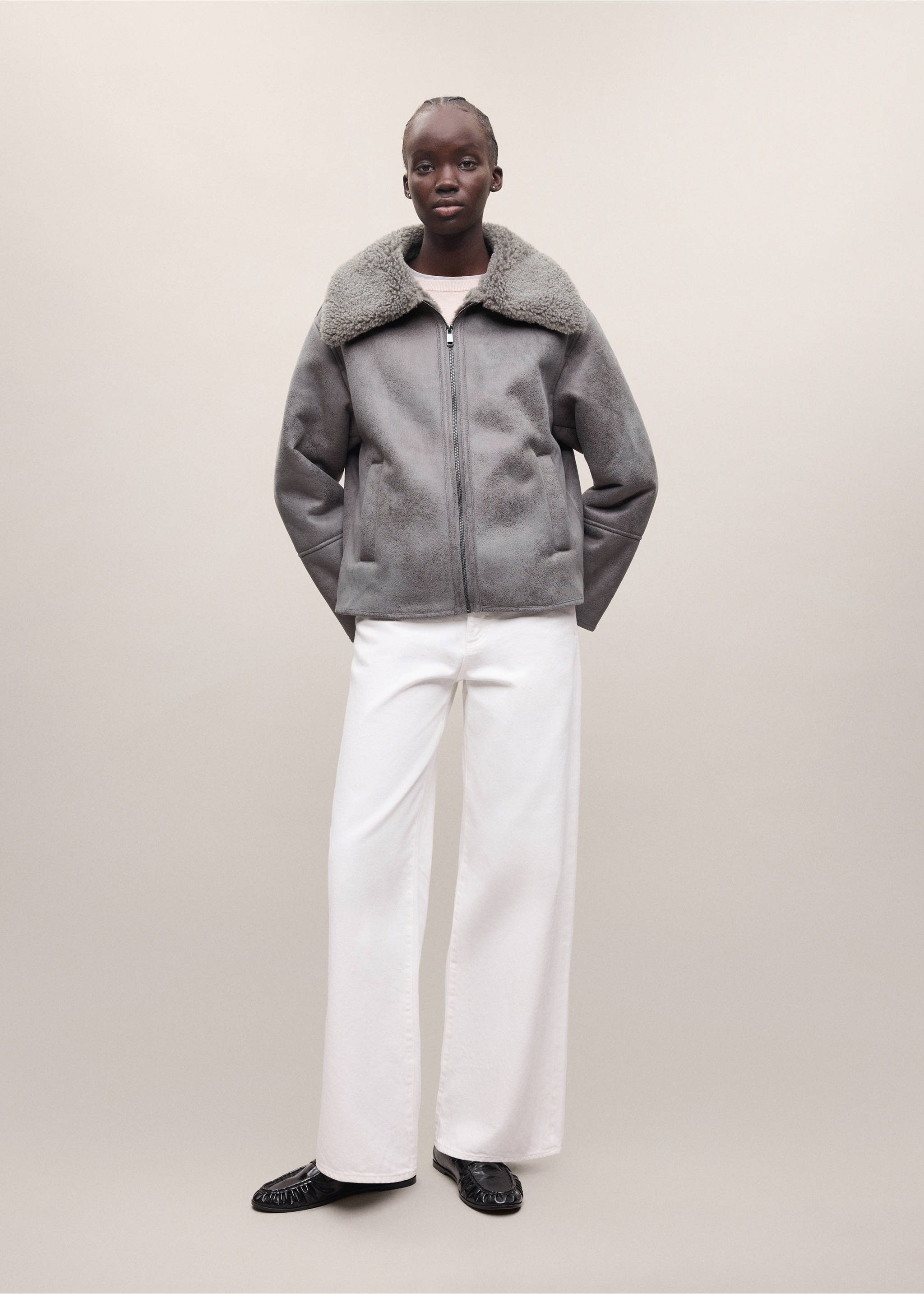 Grey faux-shearling coat with a wide collar and zip fastening, worn with white trousers., Grey. Ref: 37038282-01.