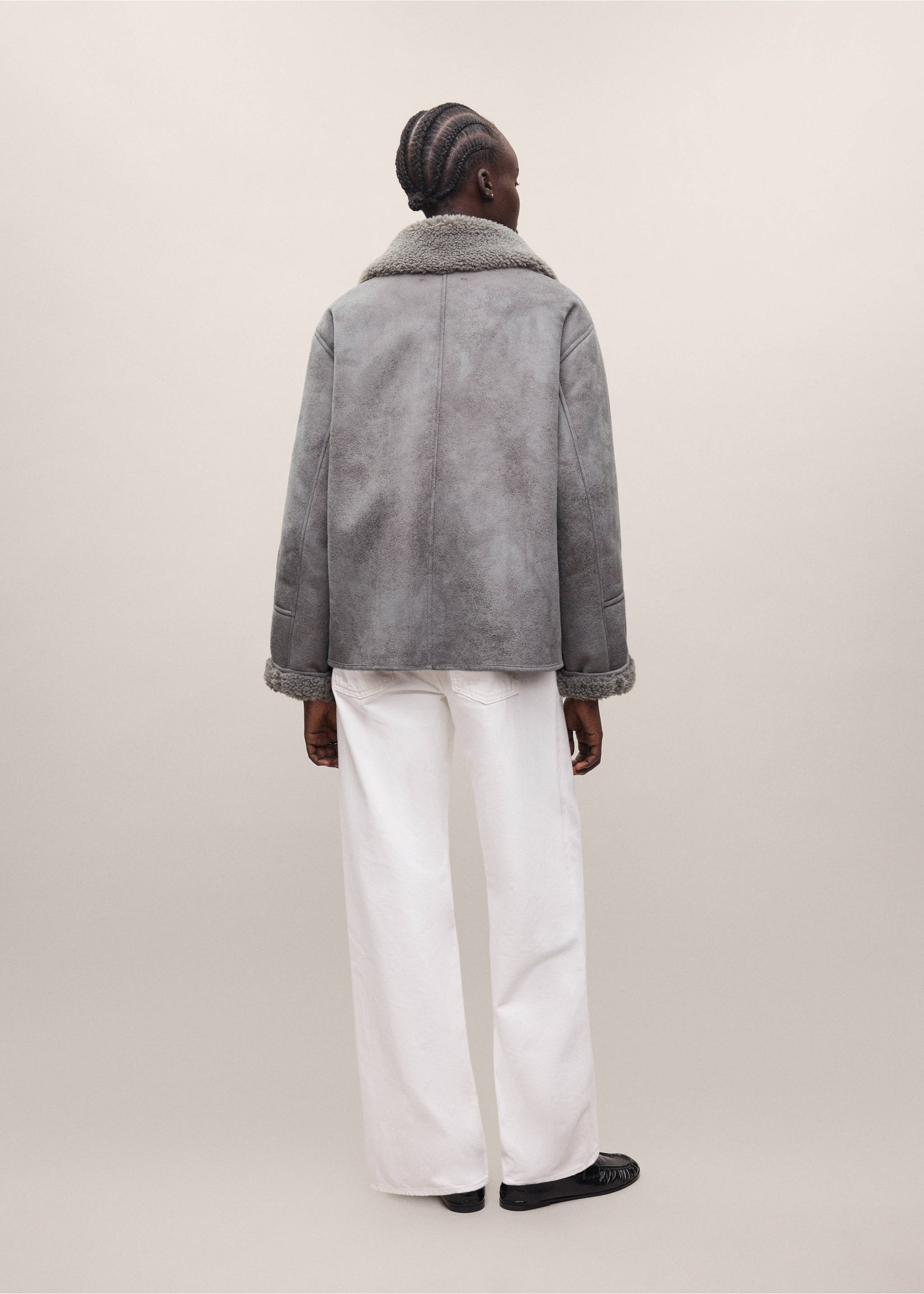 Grey faux-shearling coat shown from the back, paired with white trousers., Grey. Ref: 37038282-01.