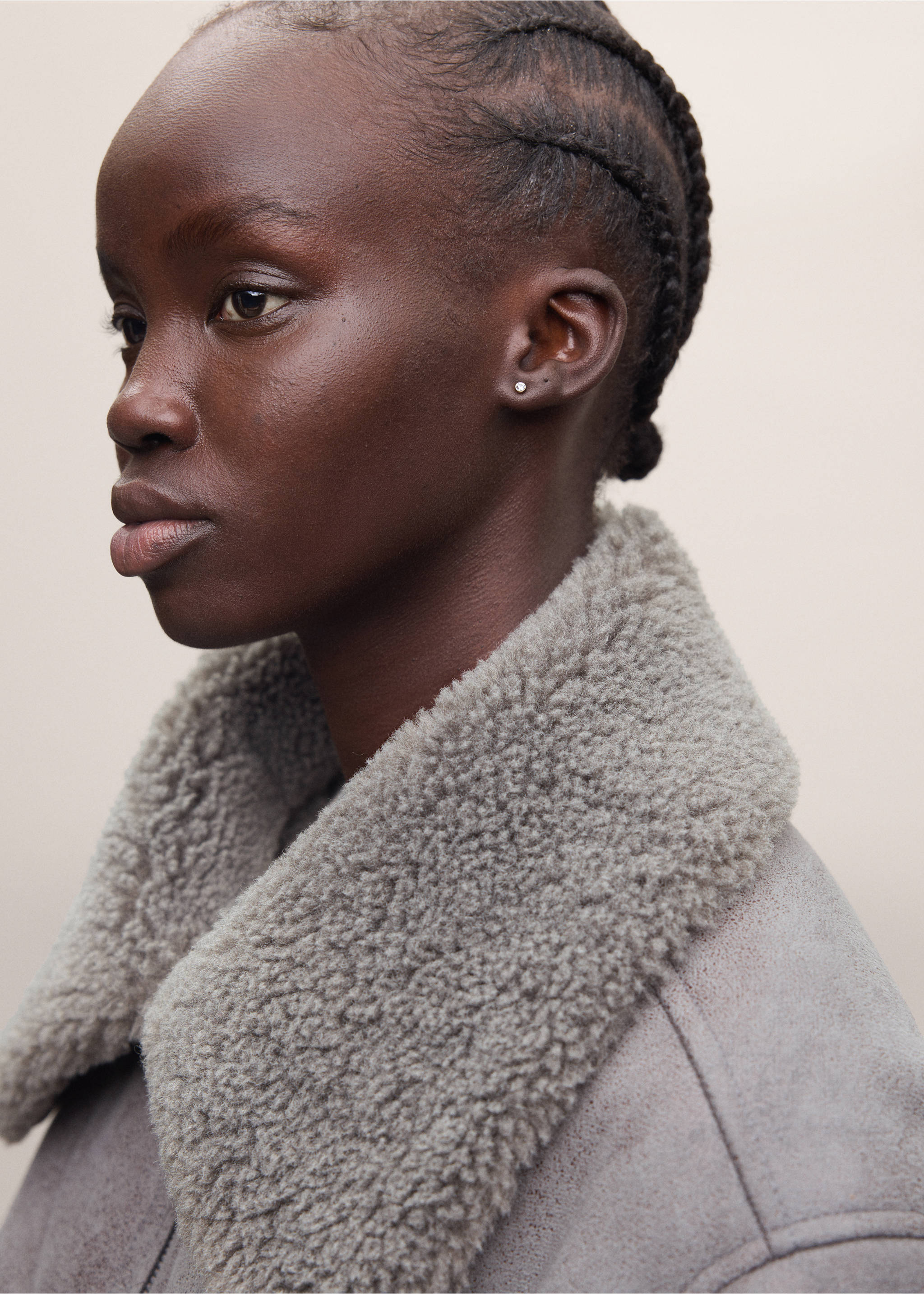 Close-up of a grey coat with a thick faux-shearling collar worn by a model., Grey. Ref: 37038282-01.