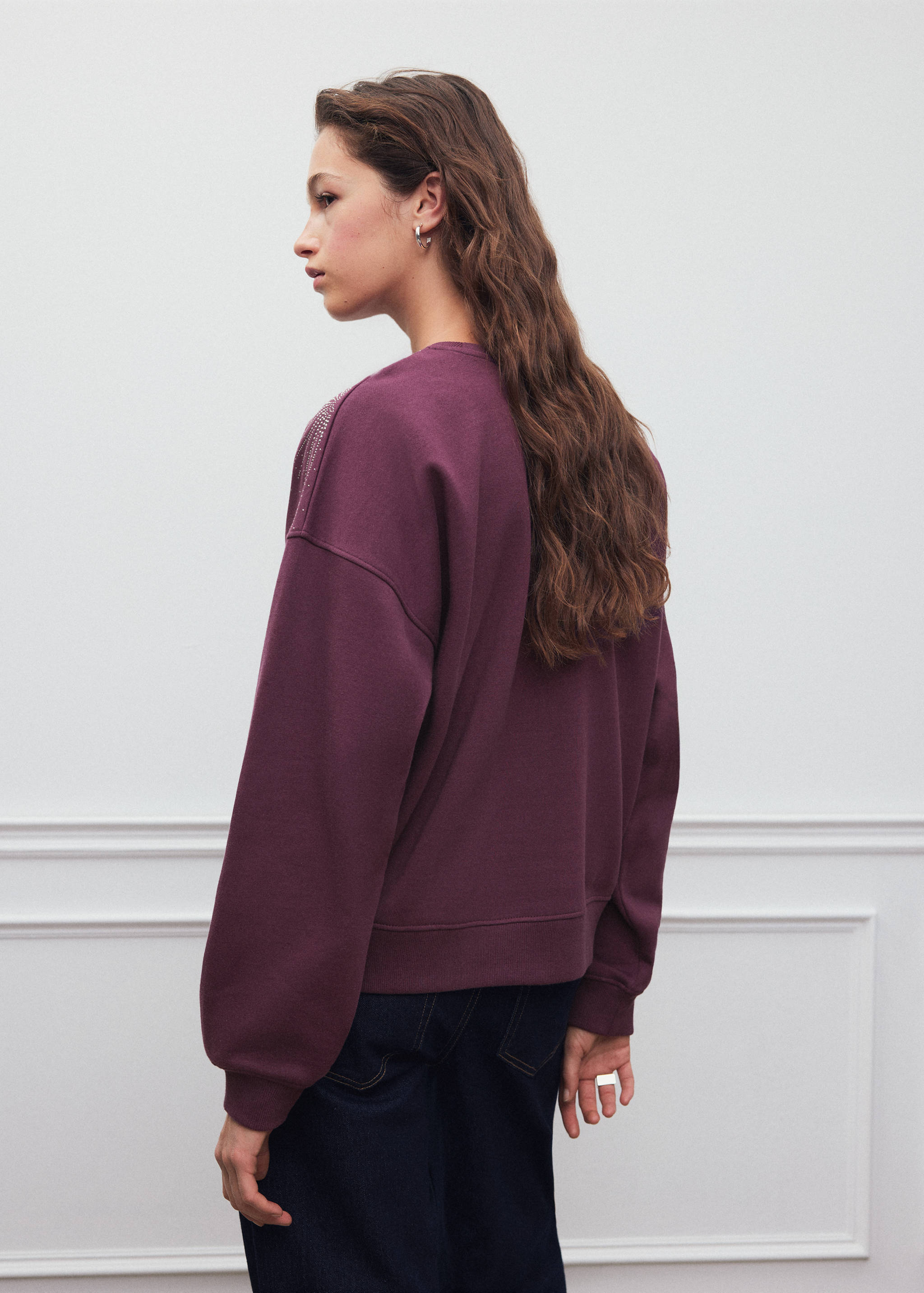 Burgundy sweatshirt with rhinestone shoulder detail, back view.
