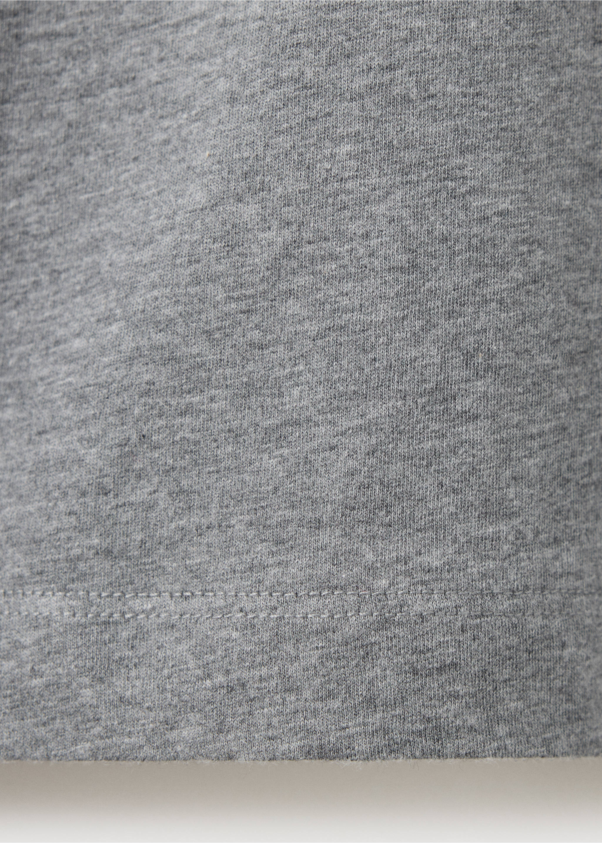Close-up of grey melange t-shirt fabric texture and hem., Medium Heather Grey. Ref: 37038637-00.