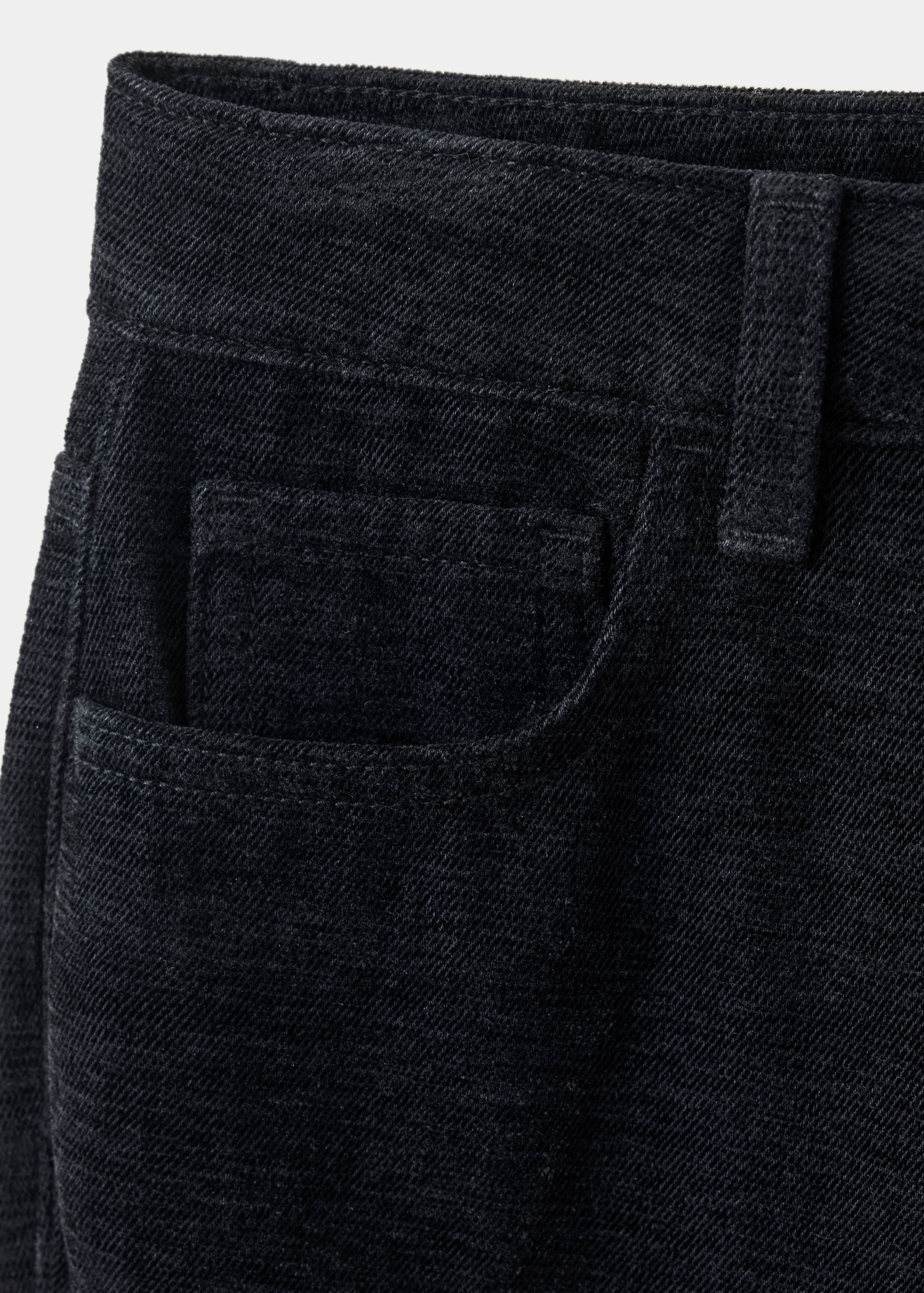 Close-up of dark grey teen jeans showing pocket and waistband detail.