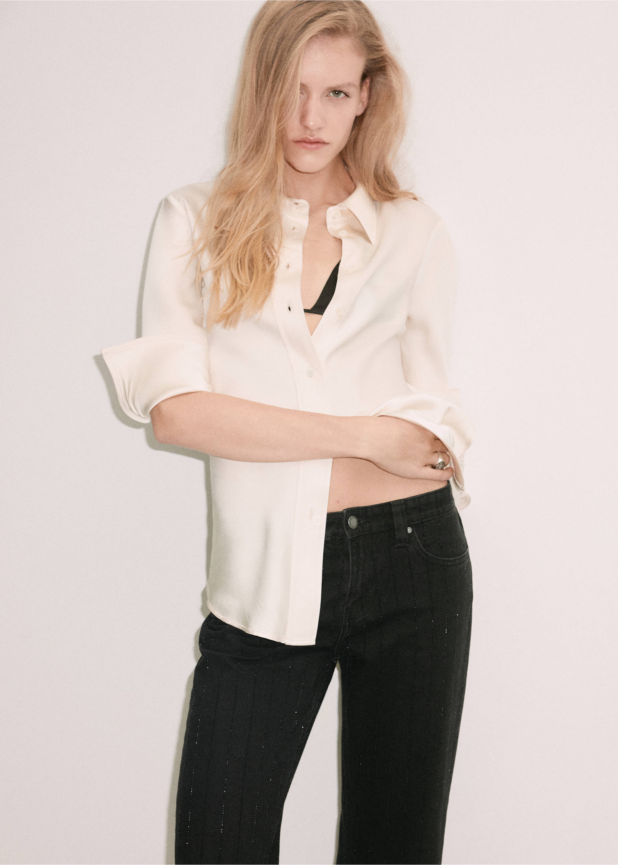 Black denim trousers with subtle vertical stripes, worn with a cream silk shirt., Black denim. Ref: 37039116-01.