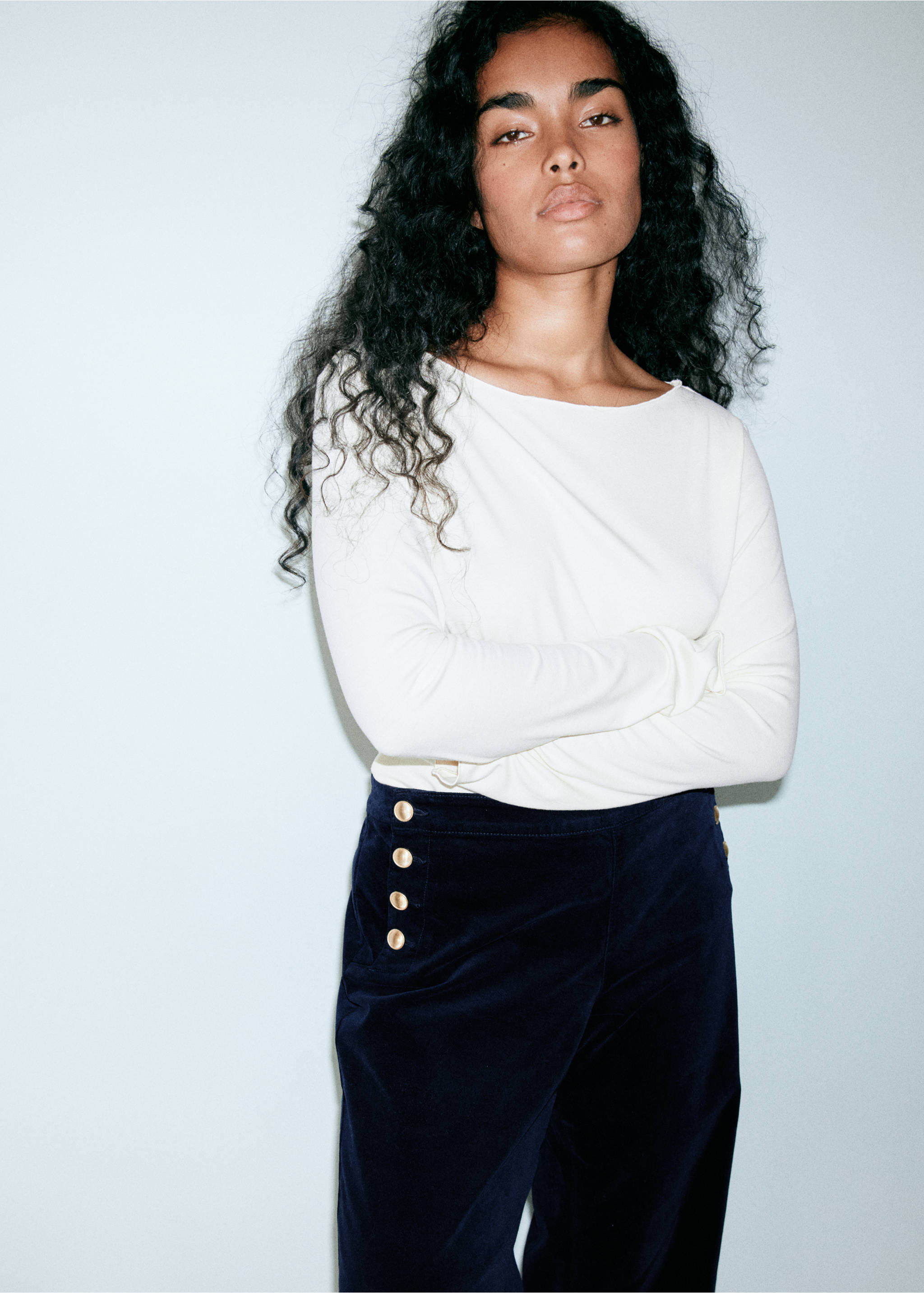 Dark blue velvet trousers featuring gold side buttons, worn with a white top., Blue. Ref: 37039117-00.