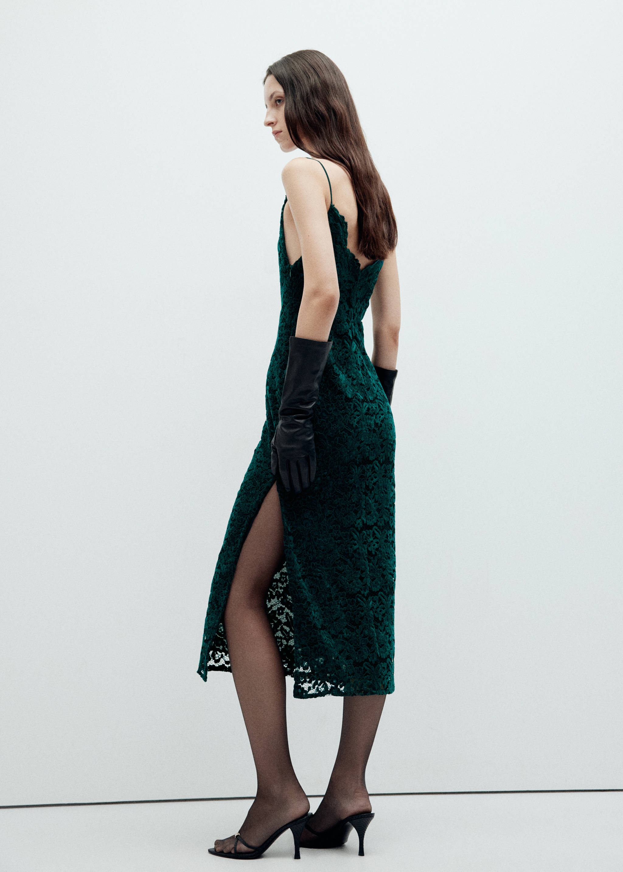 Dark green lace midi dress with thin straps and a side slit, back view.