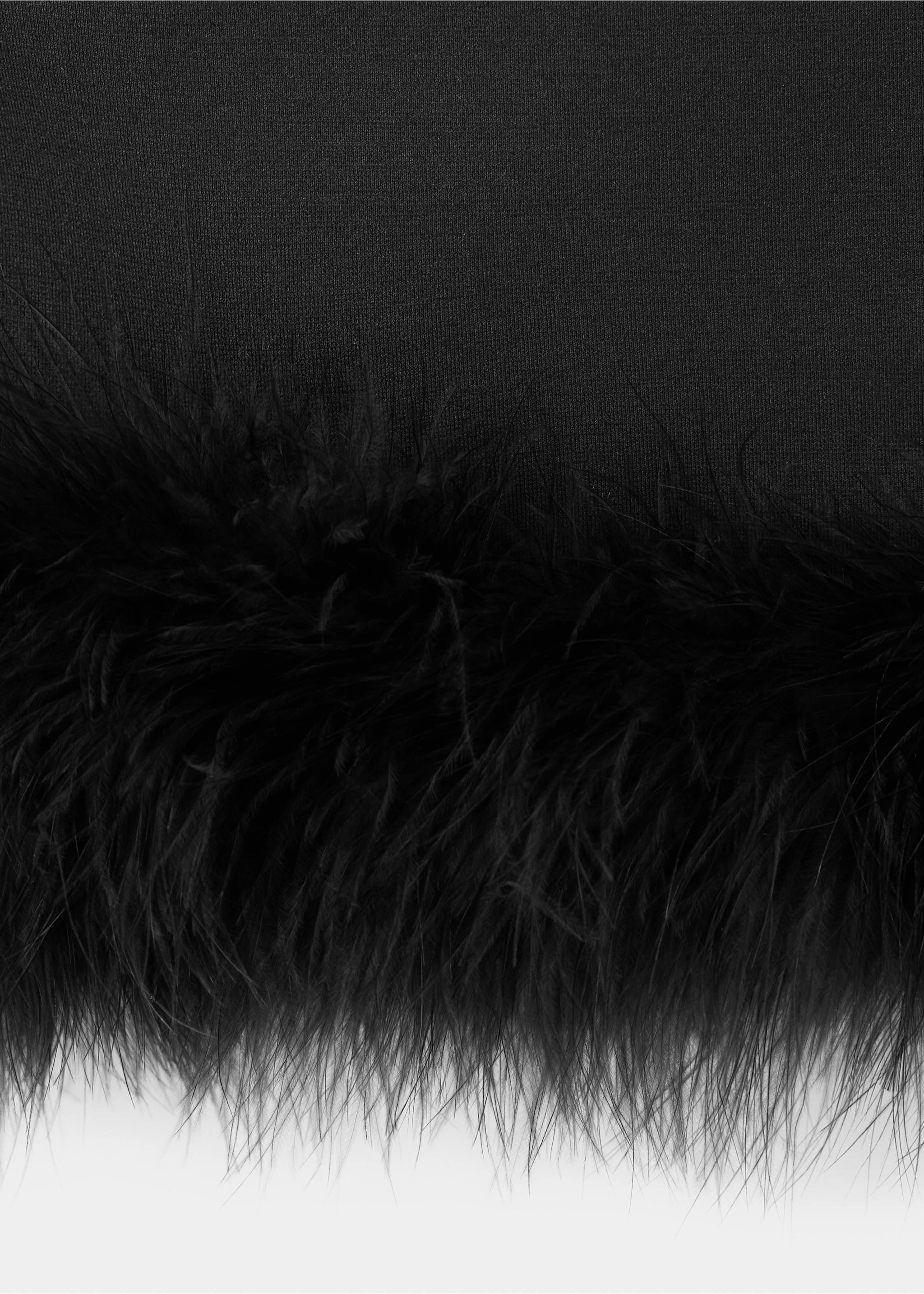 Close-up of black top with feather trim hem., Black. Ref: 37039124-00.