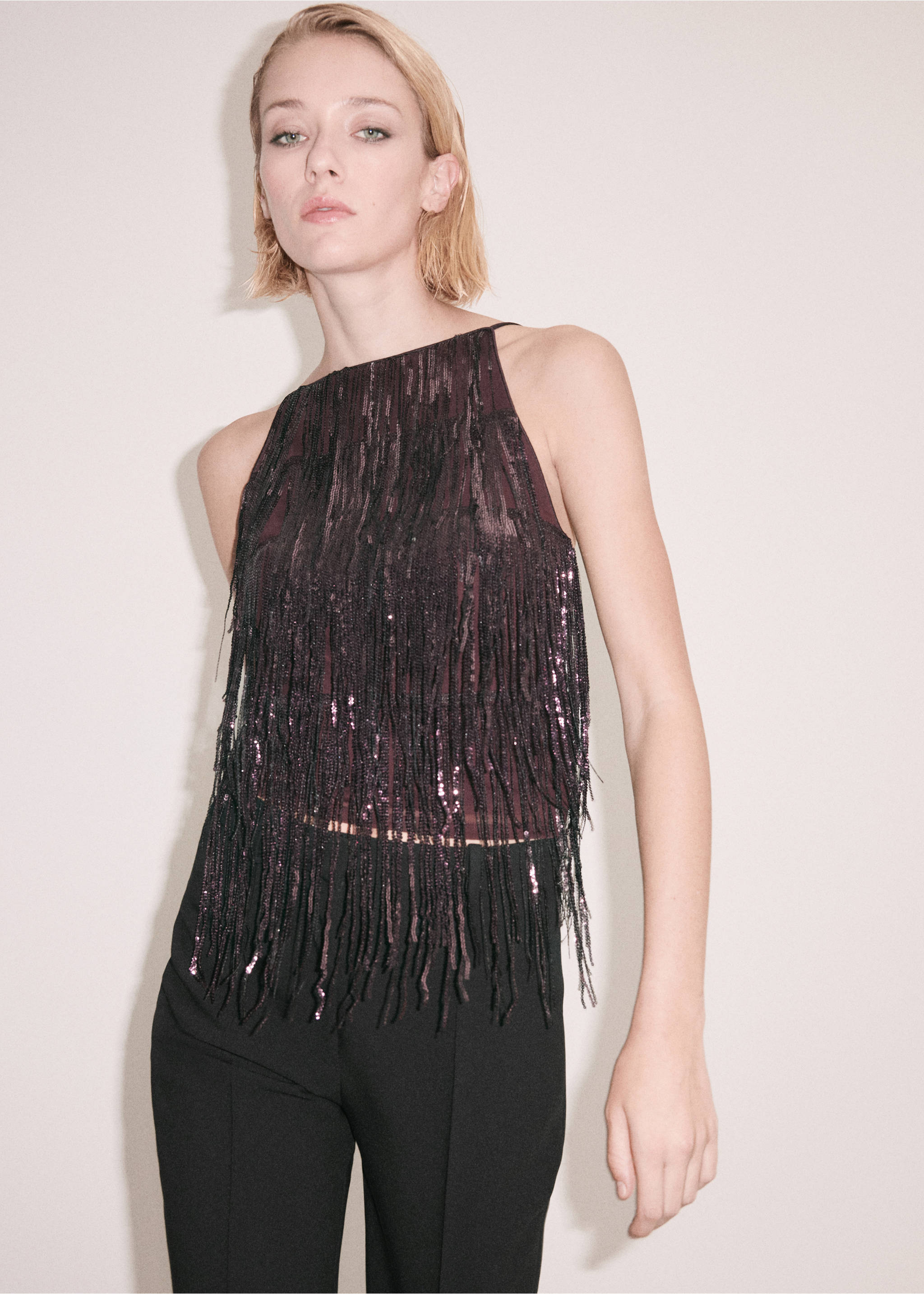 Plum halterneck top covered in sparkling fringe and sequins, worn with black trousers., Burgundy. Ref: 37039125-00.