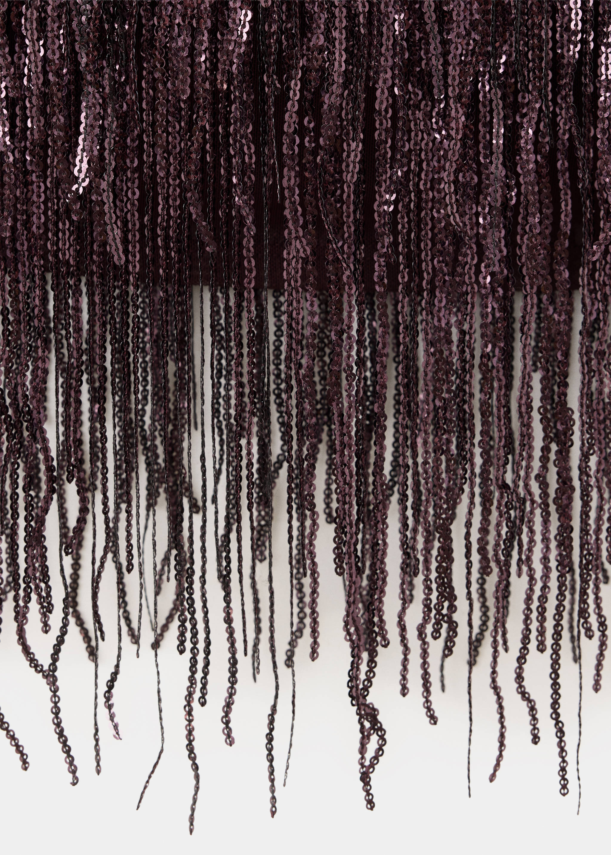 Dark plum top with long dangling sequin fringe detail.