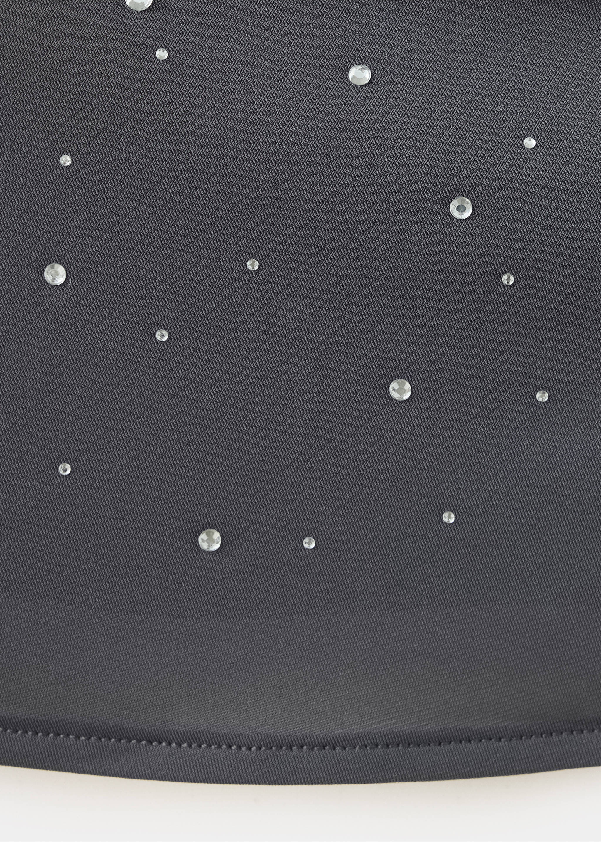Close-up of a dark grey rhinestone-embellished top fabric., Silver. Ref: 37039126-00.