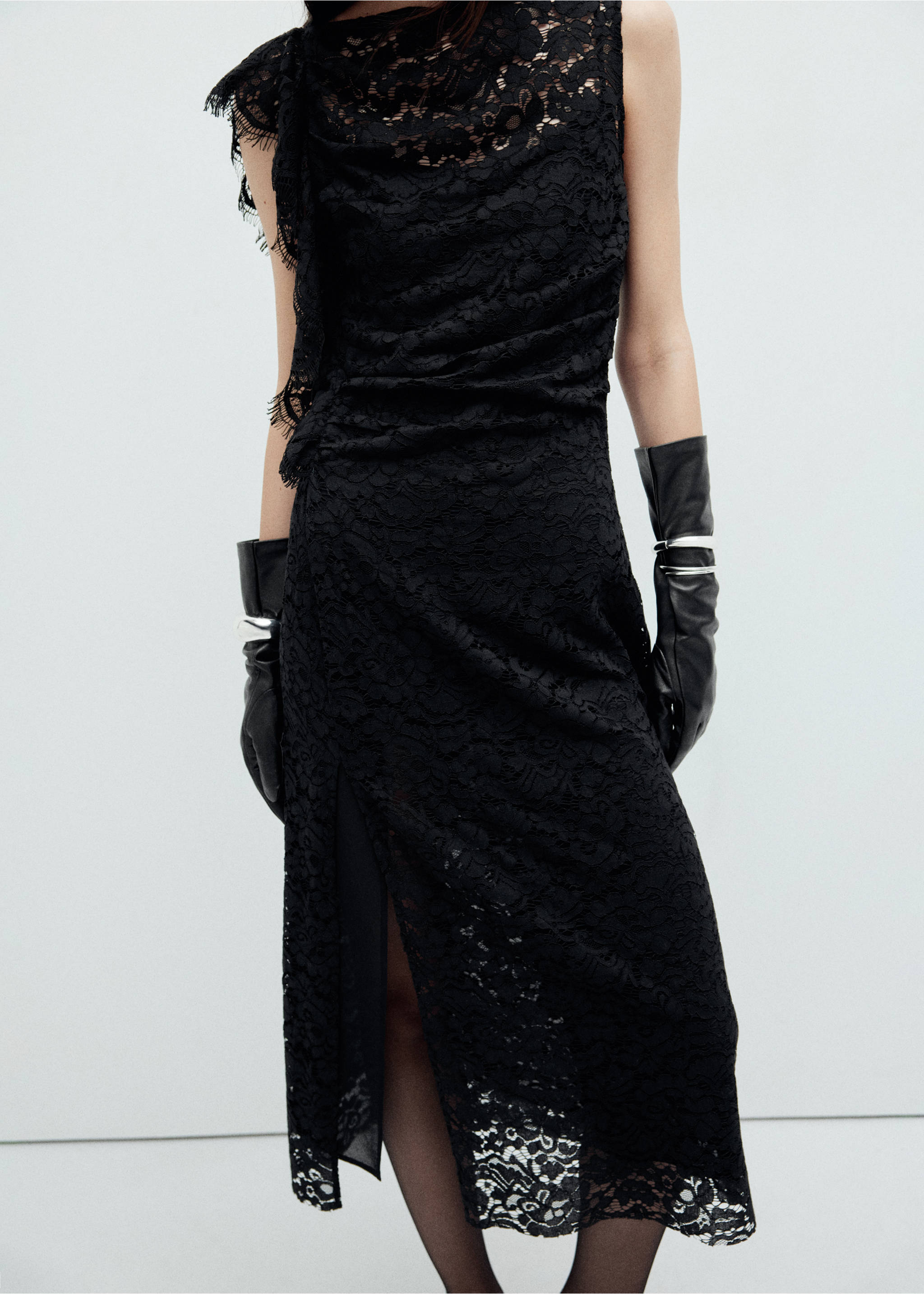 Black lace midi dress with an asymmetric cowl neck and side slit, styled with black leather gloves., Black. Ref: 37039127-00.