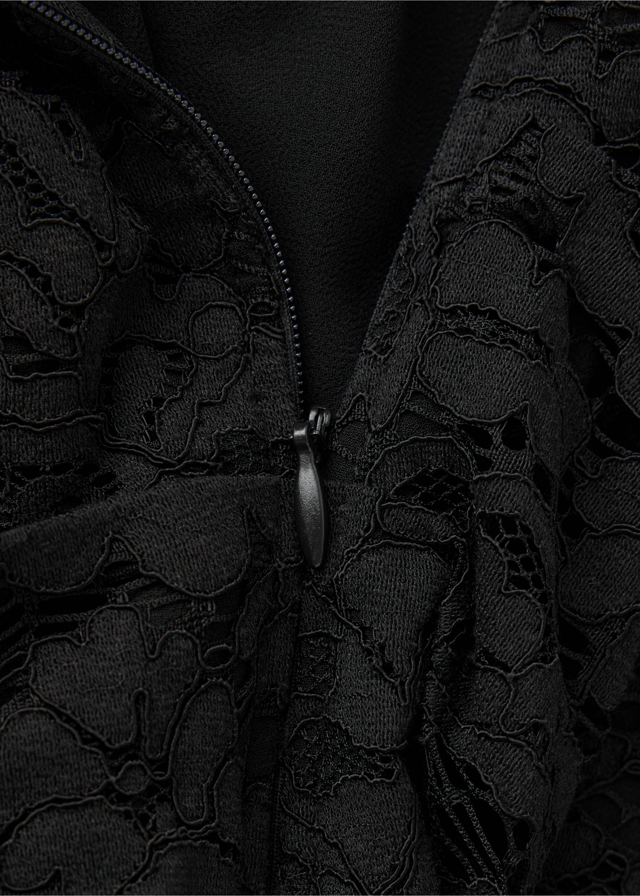 Close-up of black lace dress showing fabric texture and zip., Black. Ref: 37039127-00.