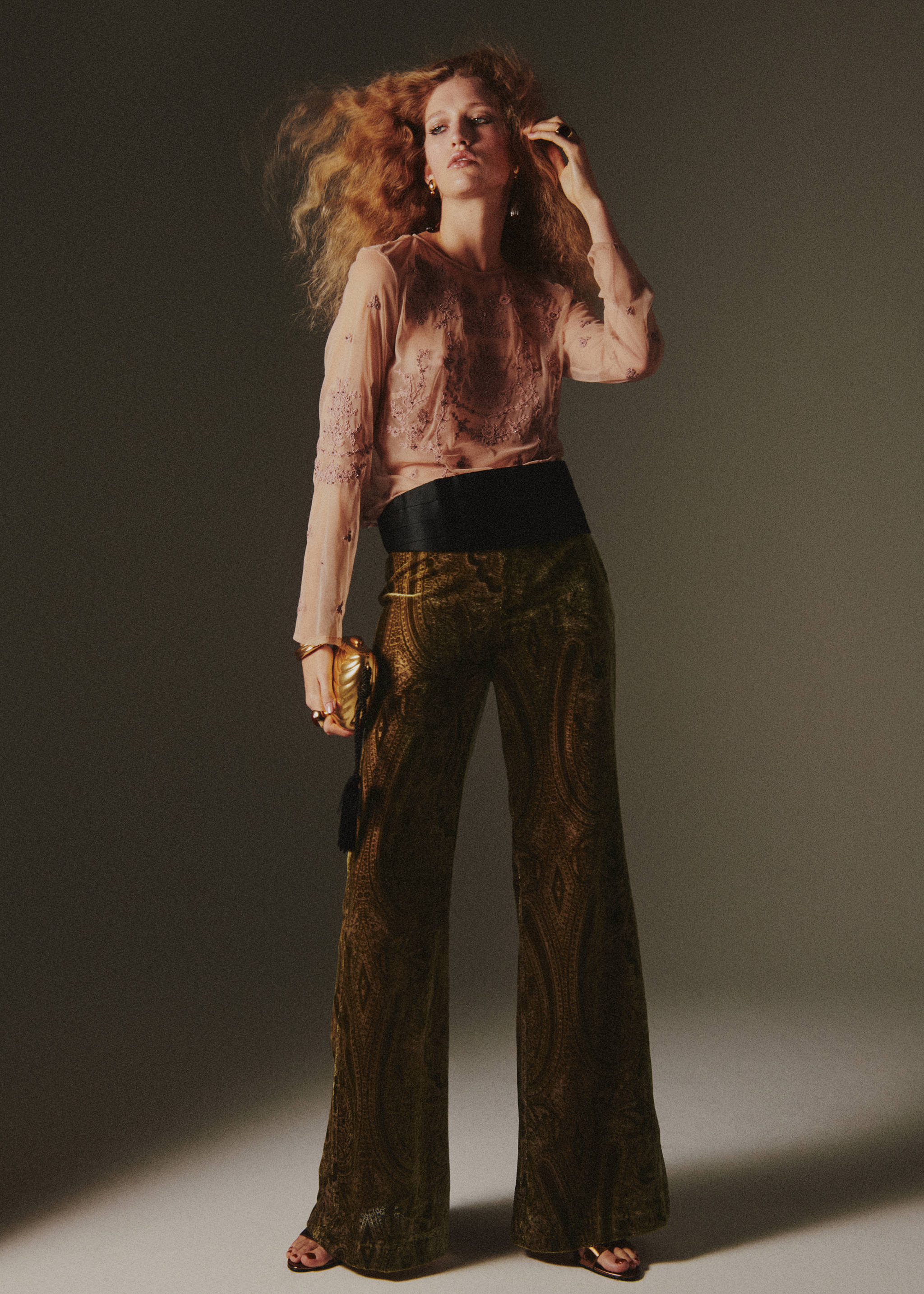 Olive green velvet paisley trousers with a flared silhouette, worn with a pink sheer blouse and black waistband., Green. Ref: 37039129-00.