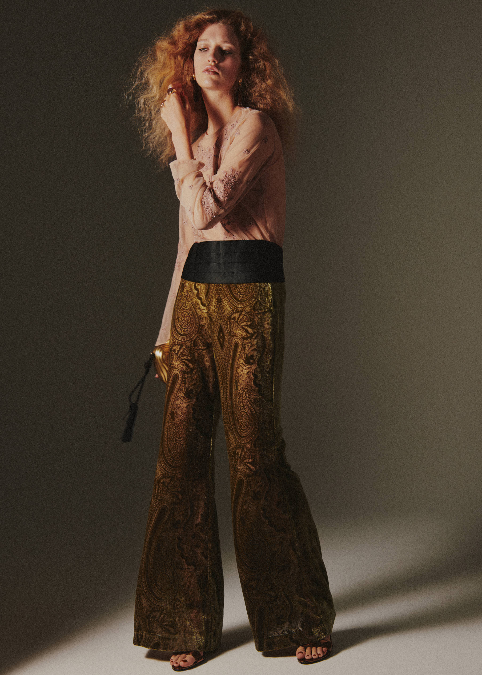 Olive green paisley velvet trousers with a wide black waistband.