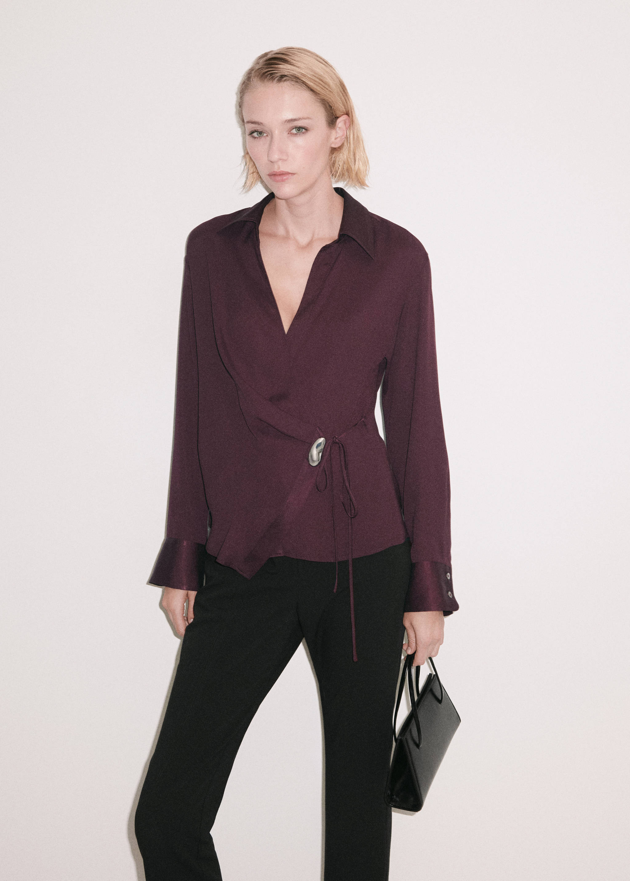 Dark plum wrap shirt with an oval buckle, long sleeves, and collar.