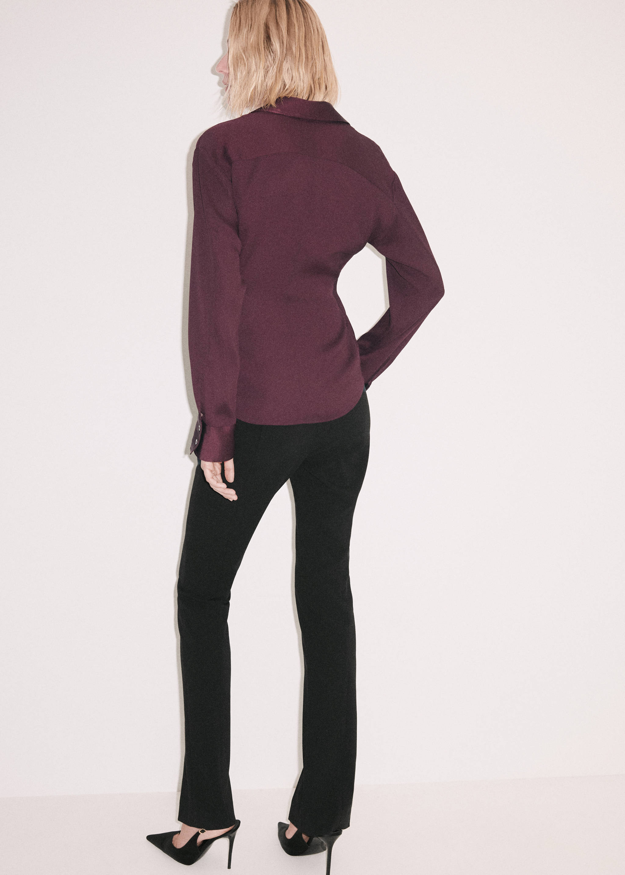 Burgundy shirt shown from the back, paired with black trousers.