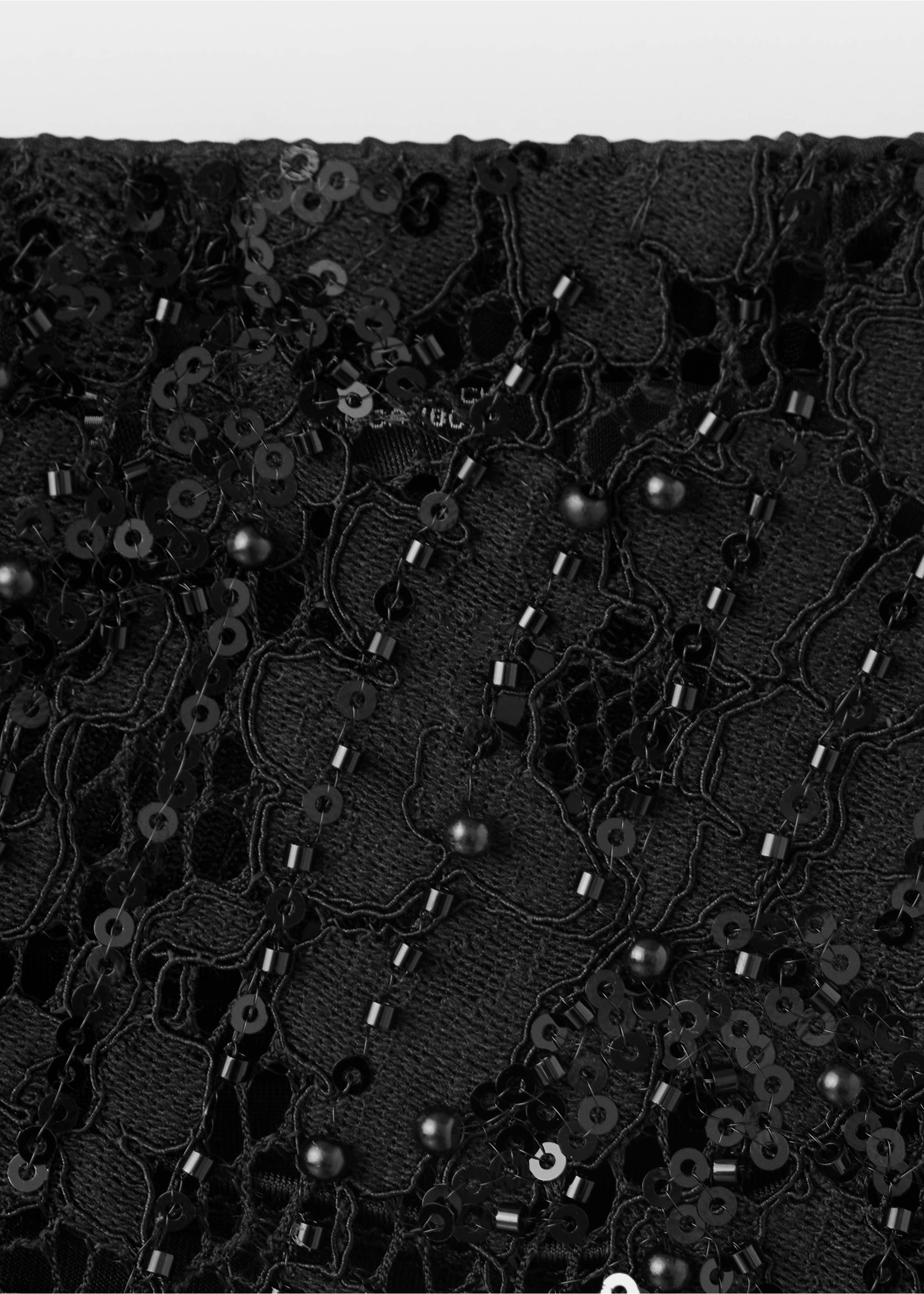 Close-up of a black skirt with sequin and bead embroidery on lace., Black. Ref: 37039131-00.