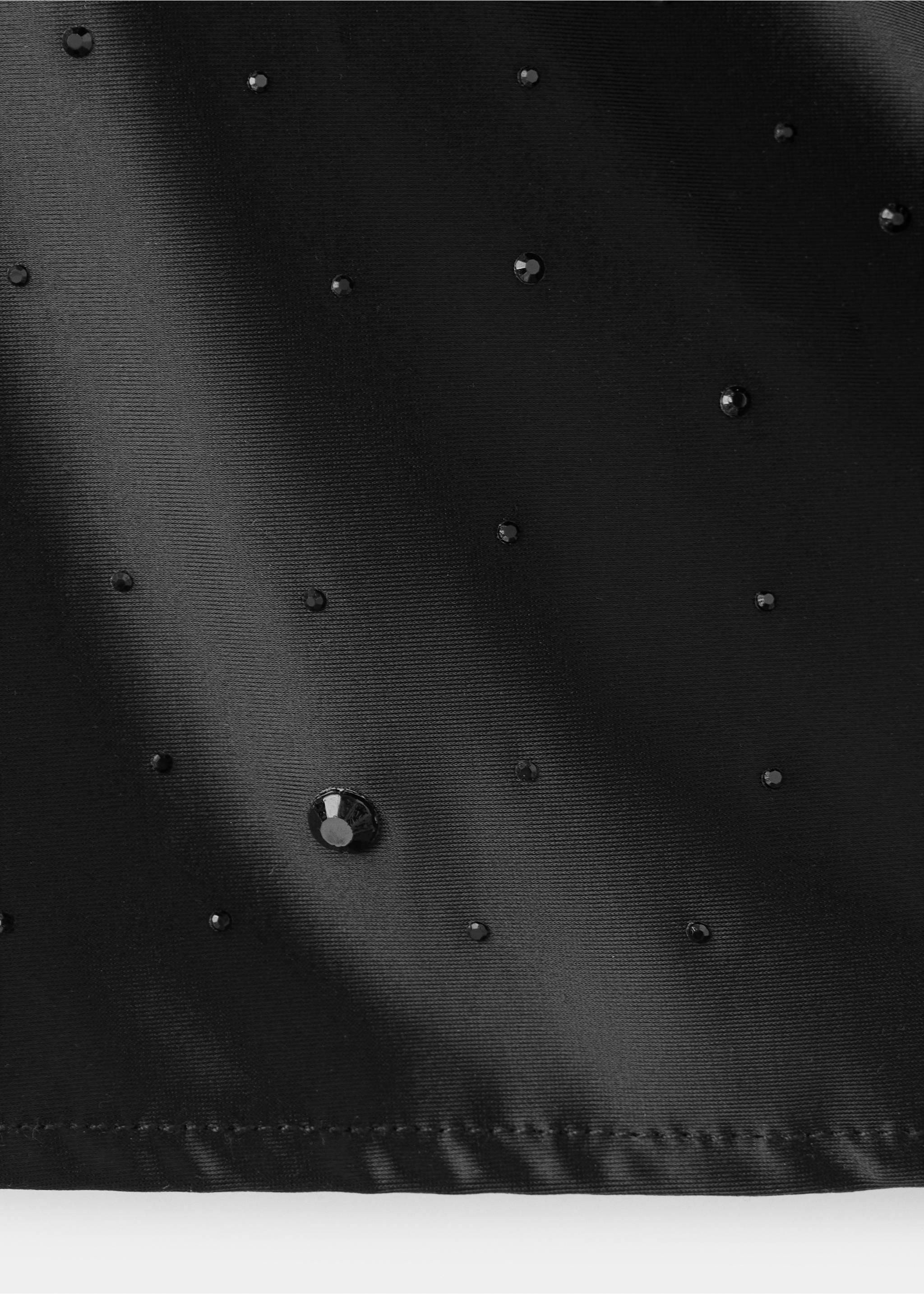 Close-up of black top fabric with scattered rhinestones., Black. Ref: 37039135-00.
