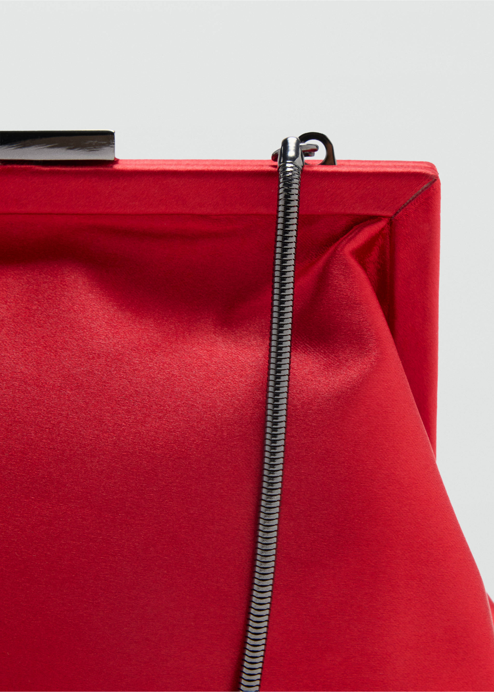 Close-up of a red satin handbag with a dark metal frame and chain strap., Red. Ref: 37039141-00.