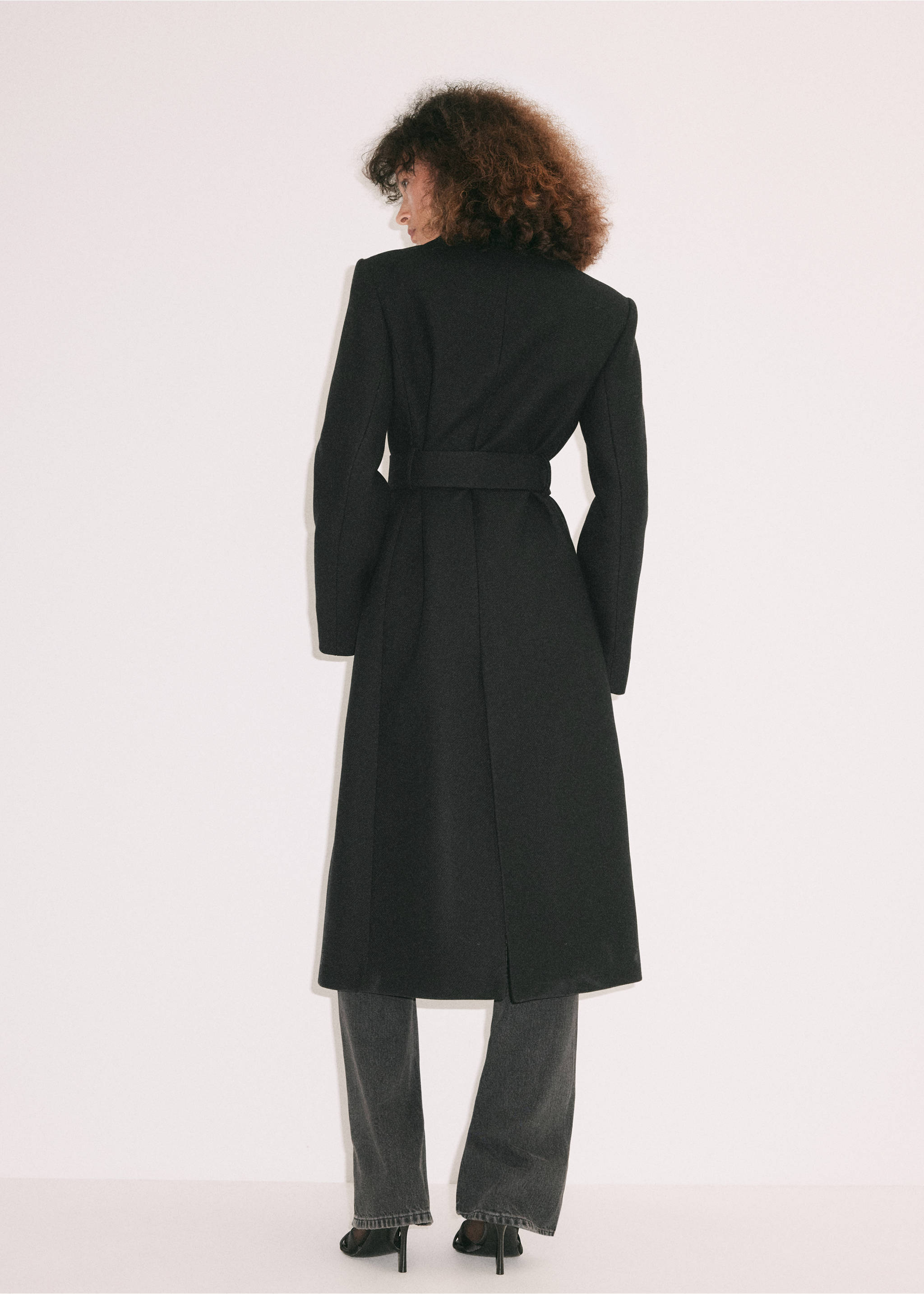 Back view of a long black coat with a waist belt., Black. Ref: 37039143-00.