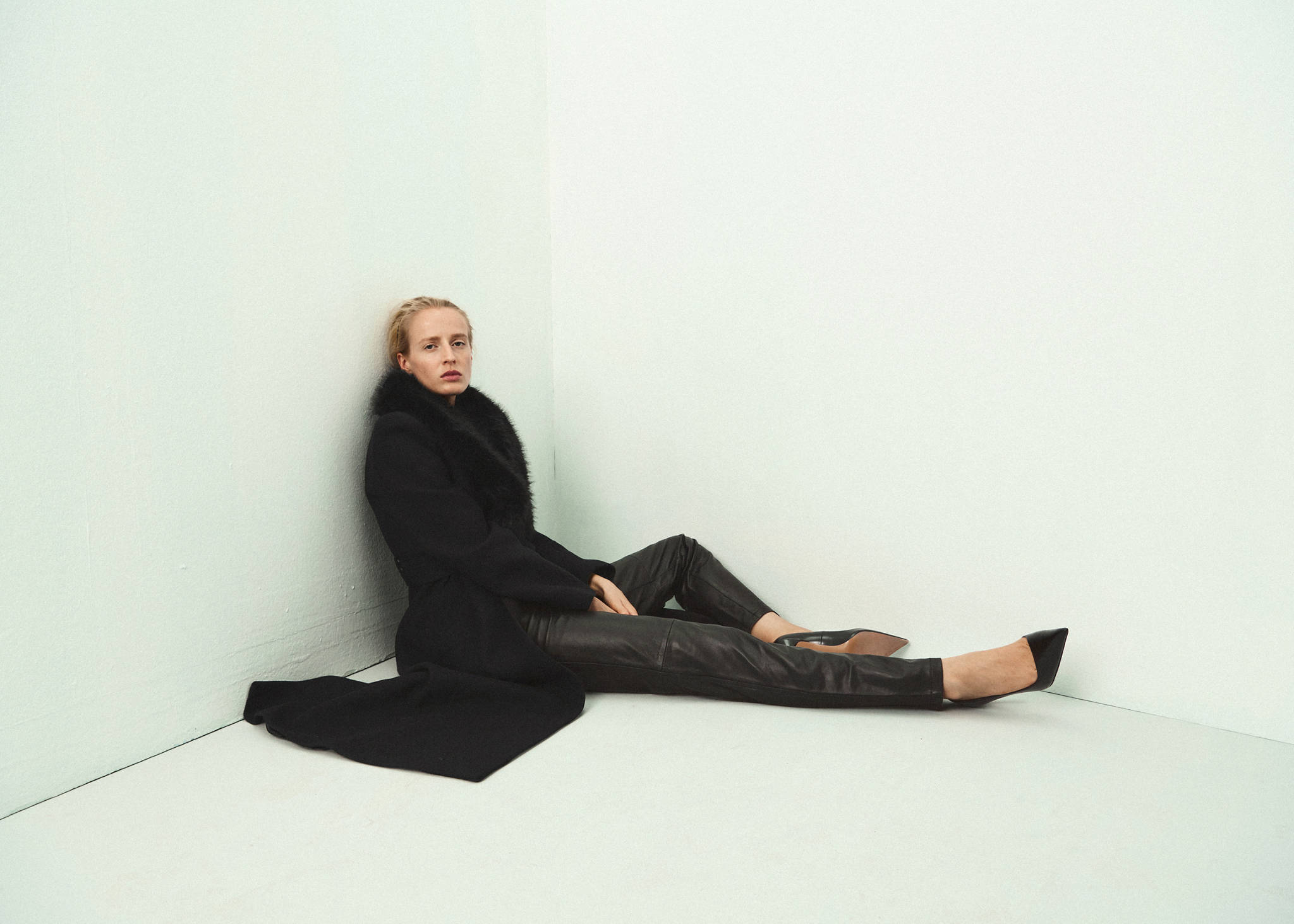 Black coat featuring a plush faux-fur collar.