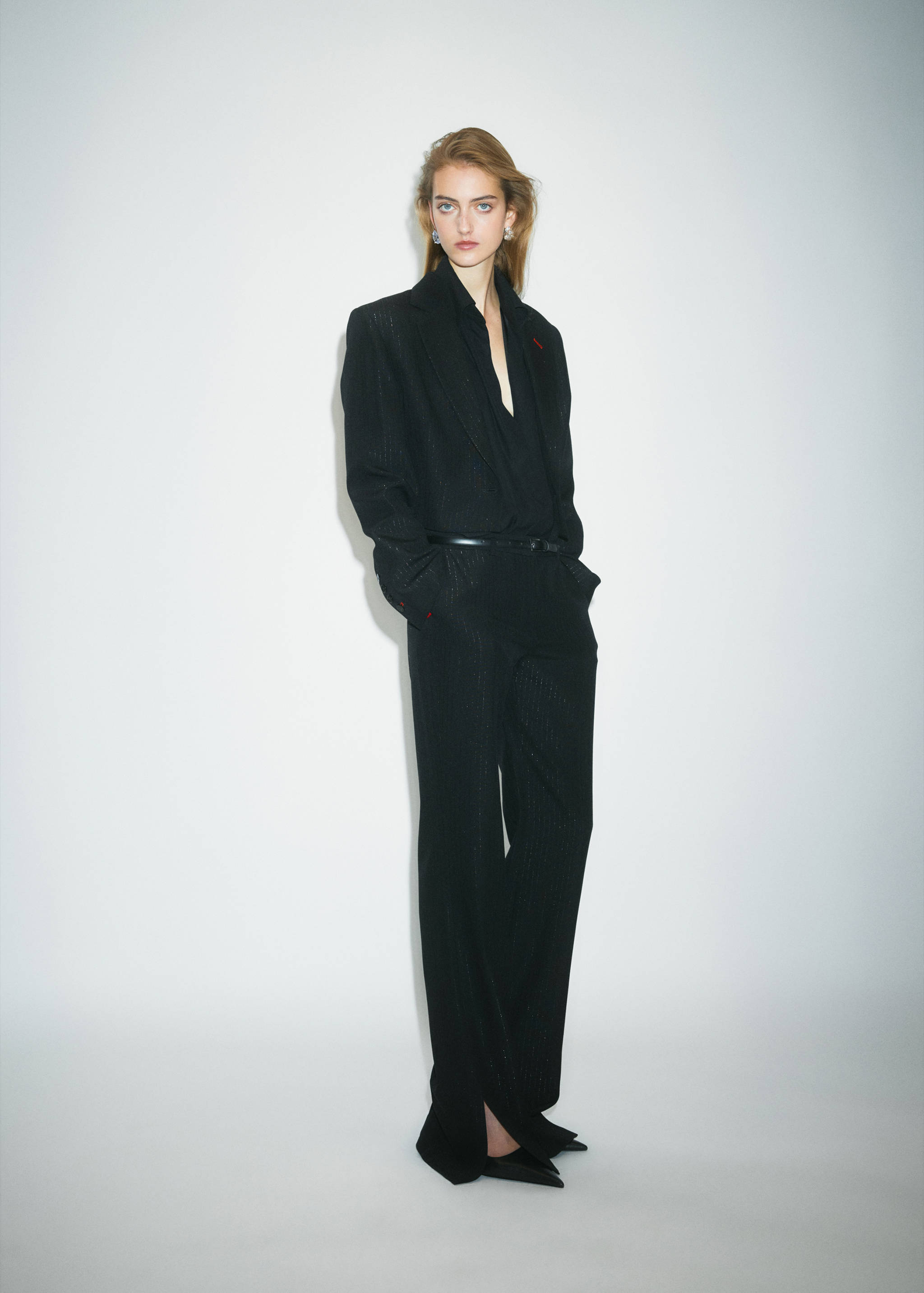 Black pinstripe trousers worn as a matching set with an oversized blazer.