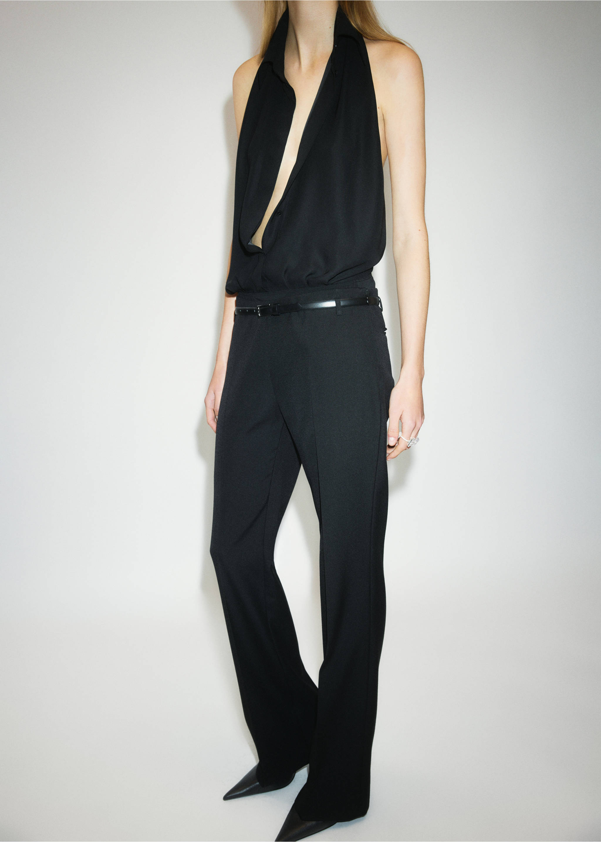 Black trousers styled with a black halter-neck top and a thin belt., Black. Ref: 37039145-00.
