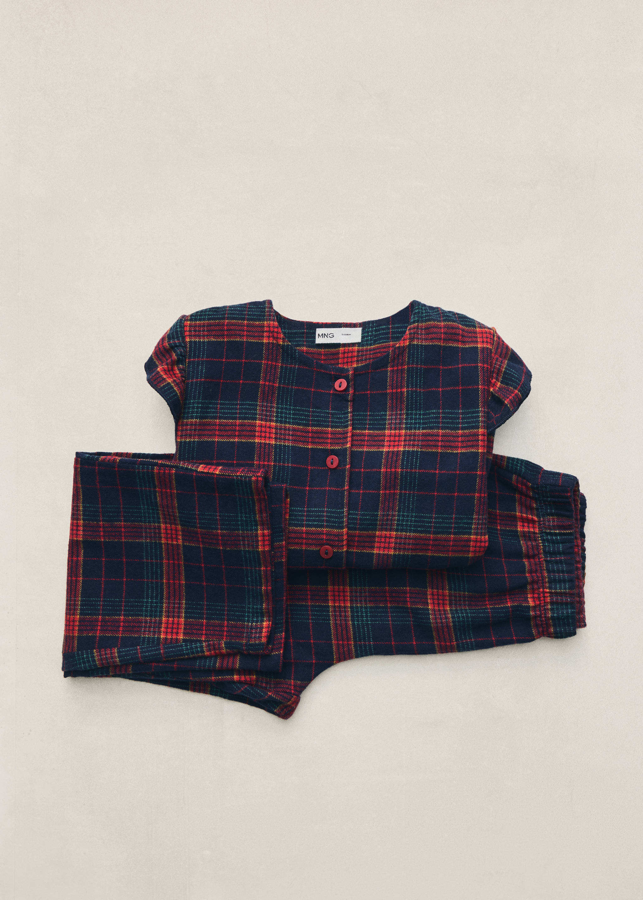 Navy blue, red, and green plaid children's pyjama set with short sleeves.