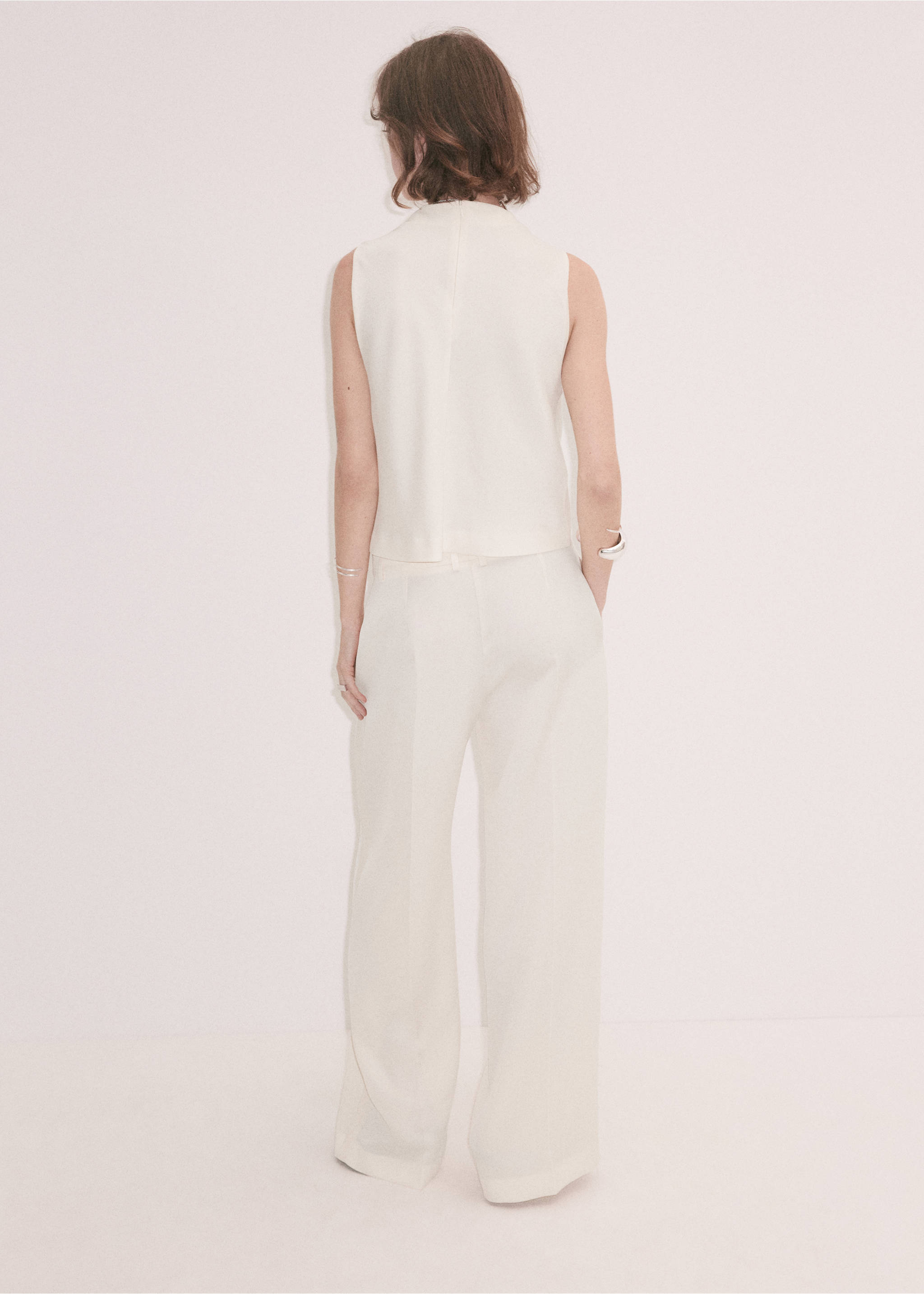 Cream sleeveless top shown from the back, paired with trousers, Ecru. Ref: 37039214-00.